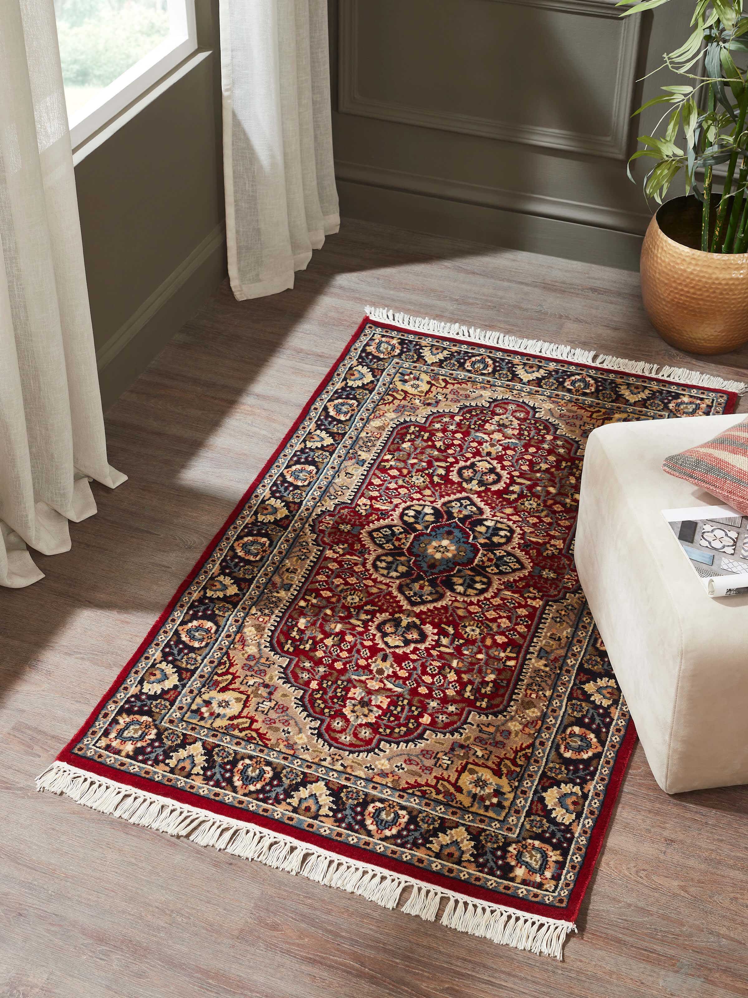 Top-down view highlighting the intricate rust and complementary color patterns typical of Kashan designs