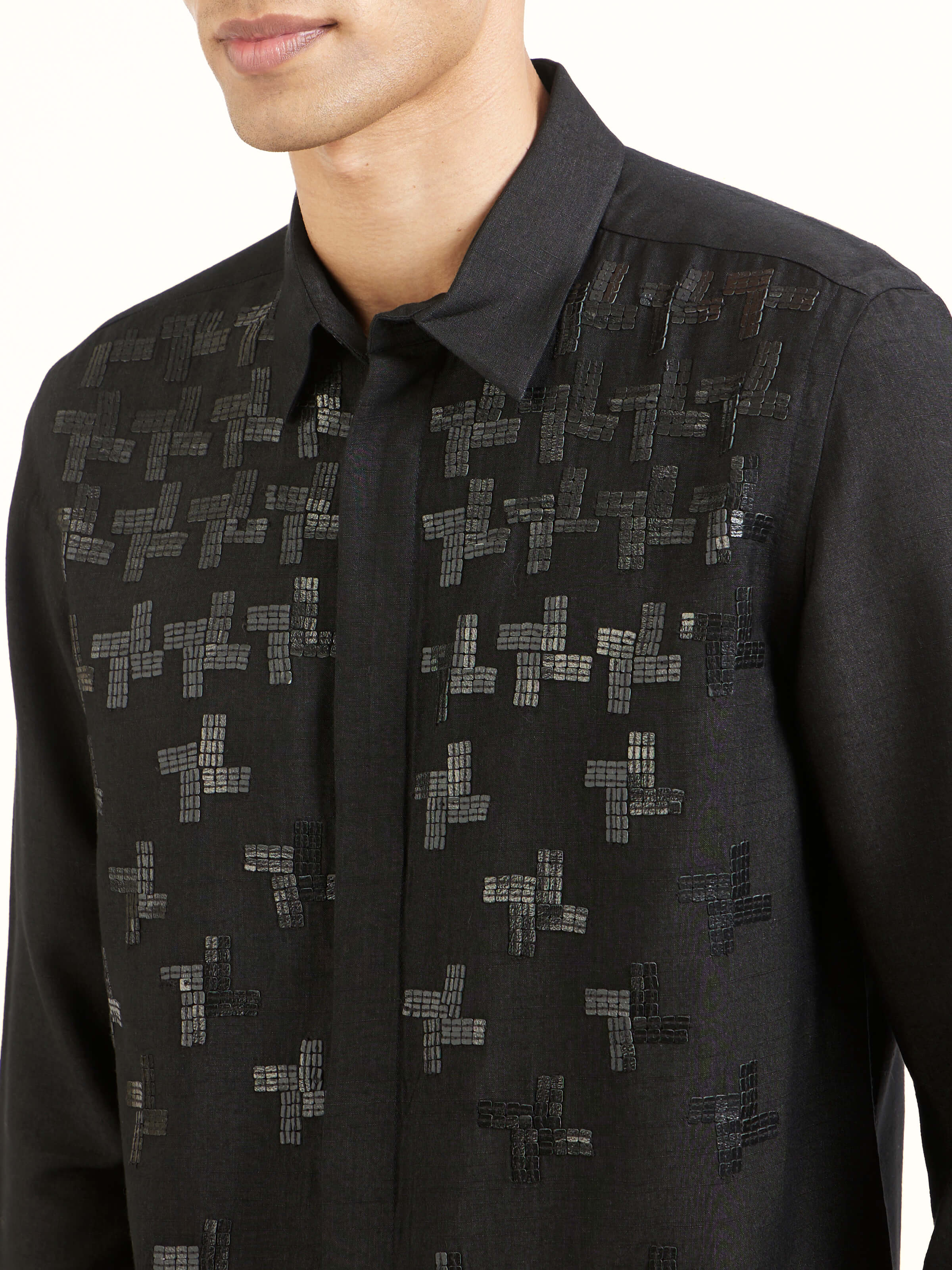 Detail view of black hand embroidery shirt showing craftsmanship