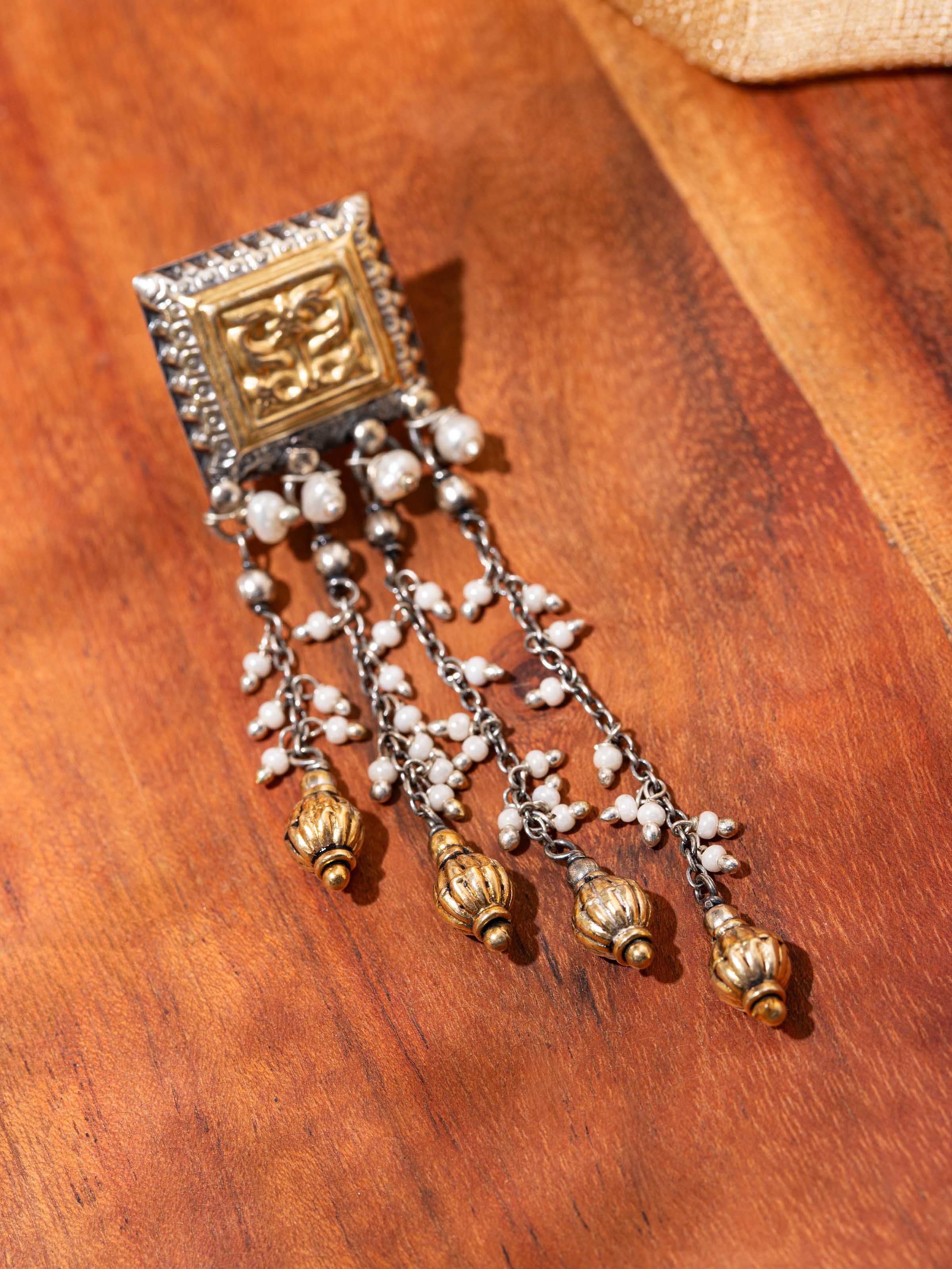 Detail shot of silver smithing drop earrings