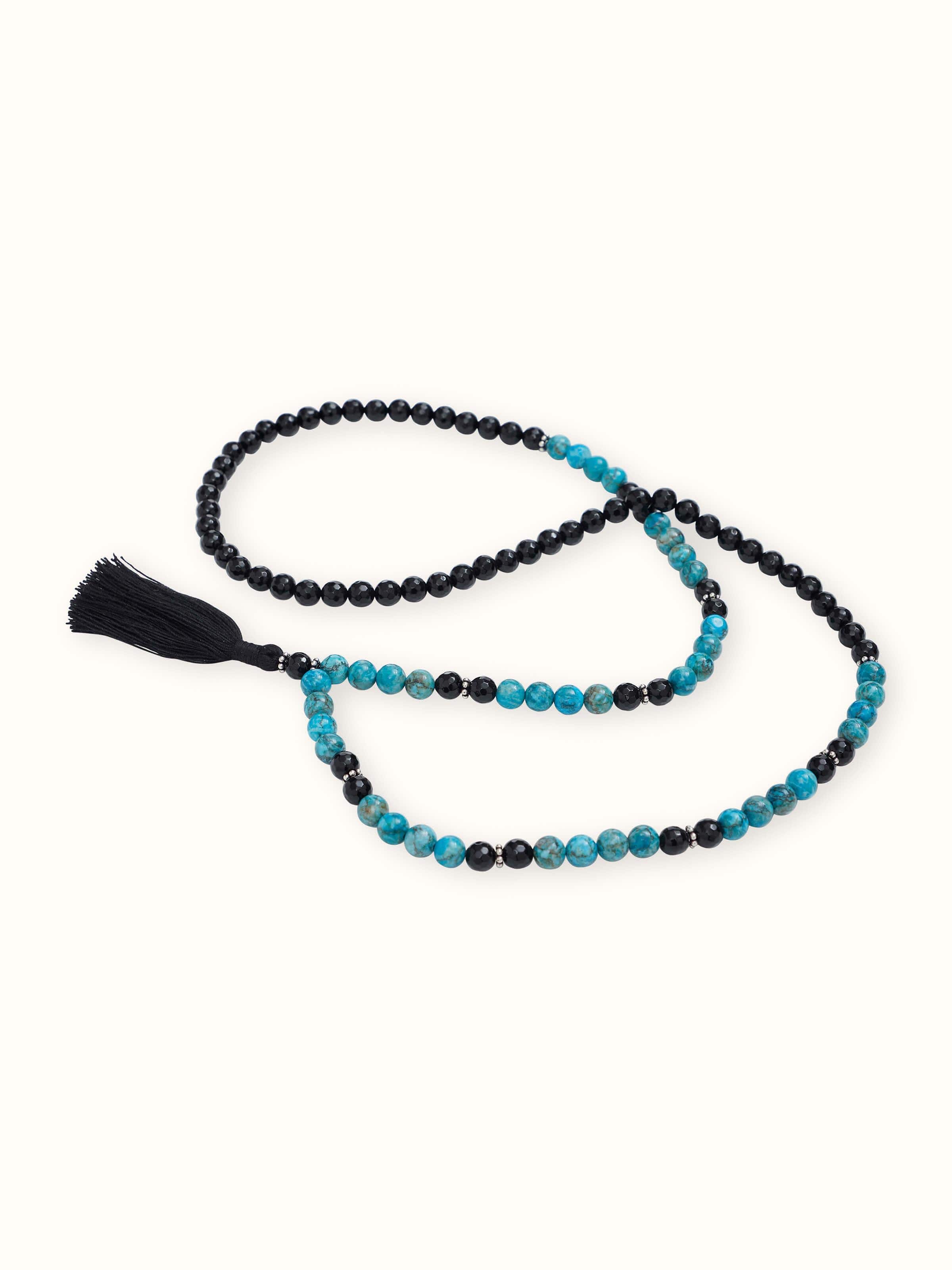 Angled overhead view of Black Onyx & Turquoise Mala emphasizing texture contrast and design balance
