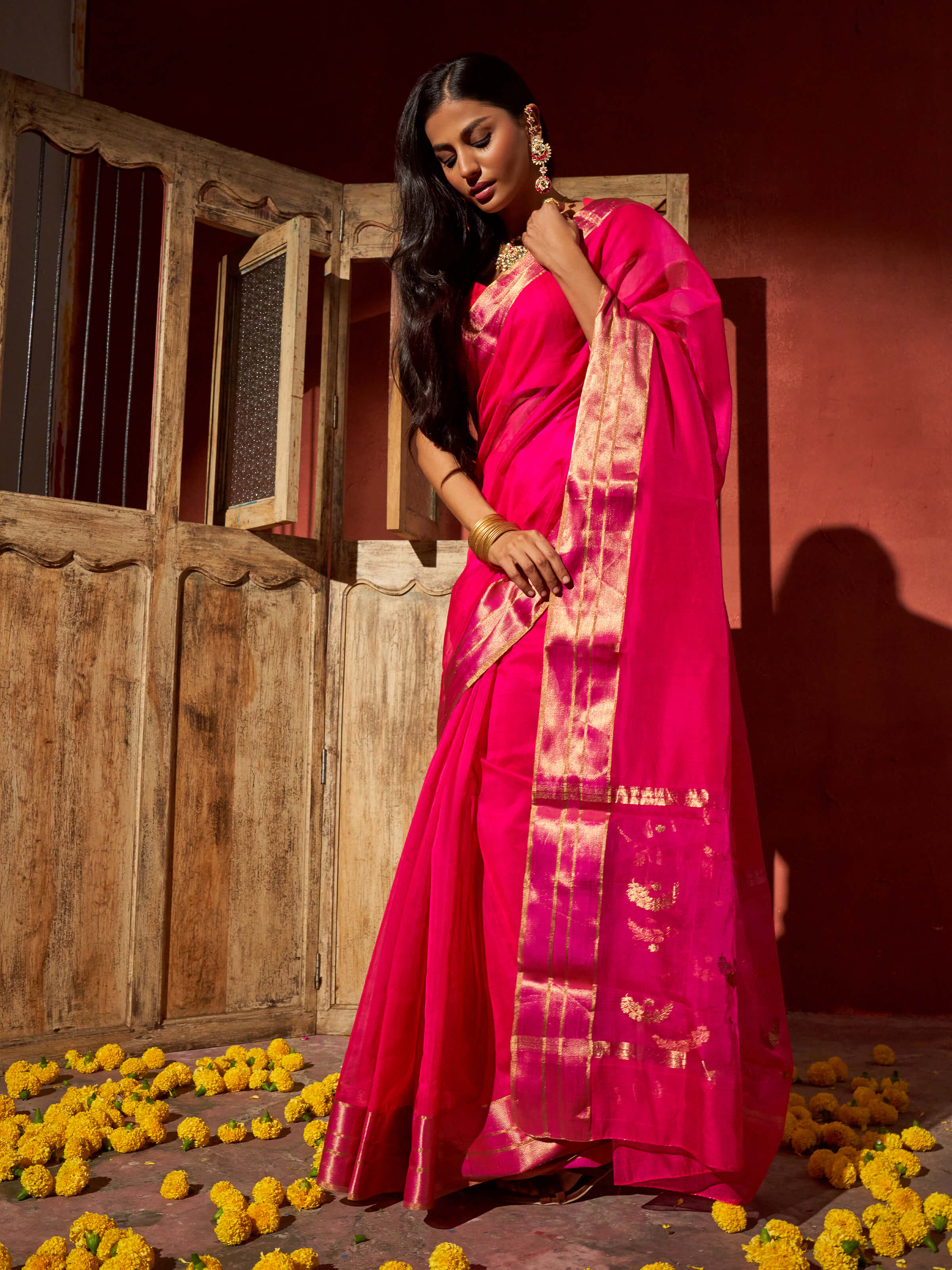 Angled view of yellow cotton silk Chanderi saree highlighting woven motifs