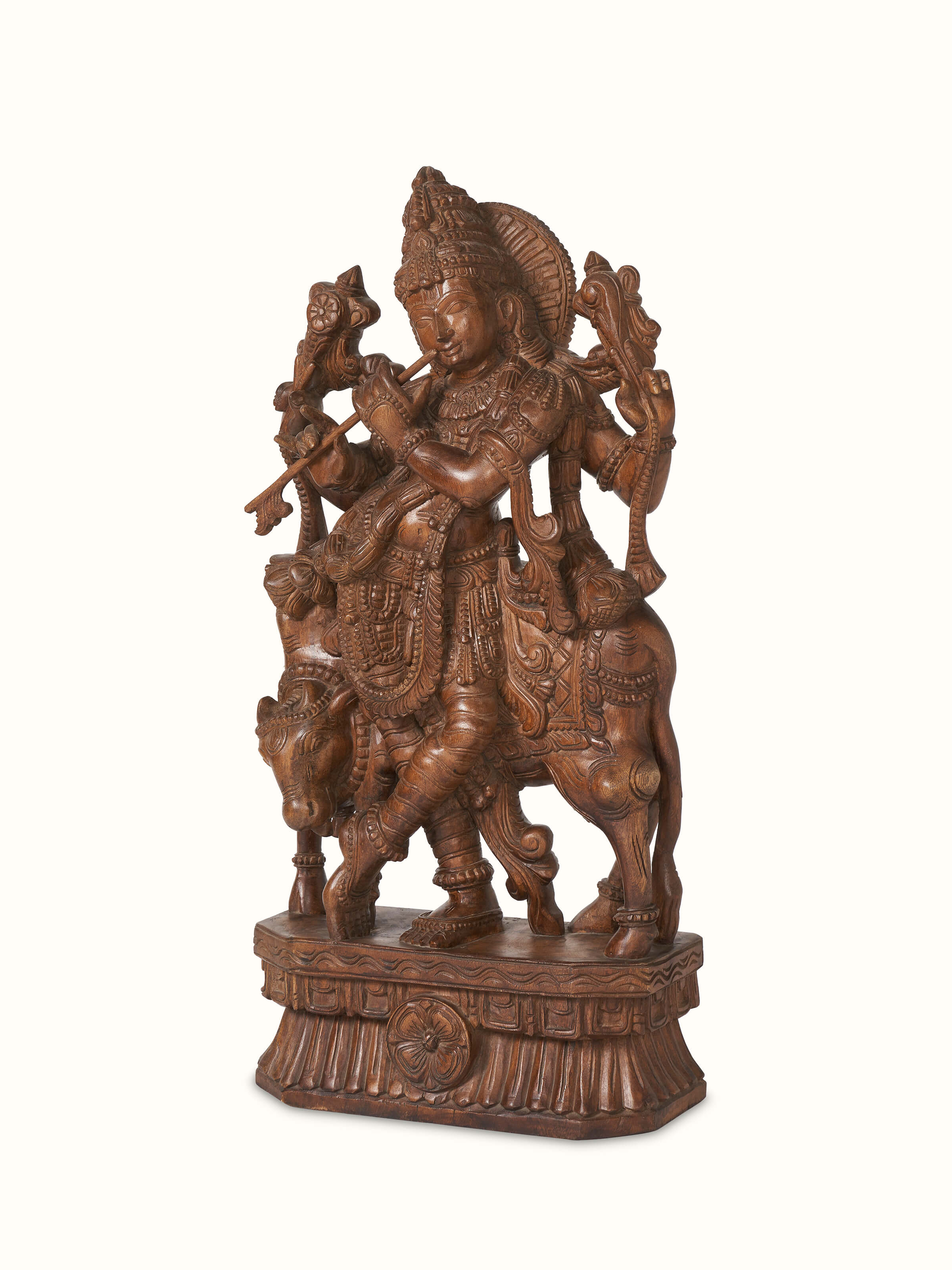 Side view of Ananta Mara Silai carved Vaagai wood Krishna with flute idol, highlighting the detailed craftsmanship