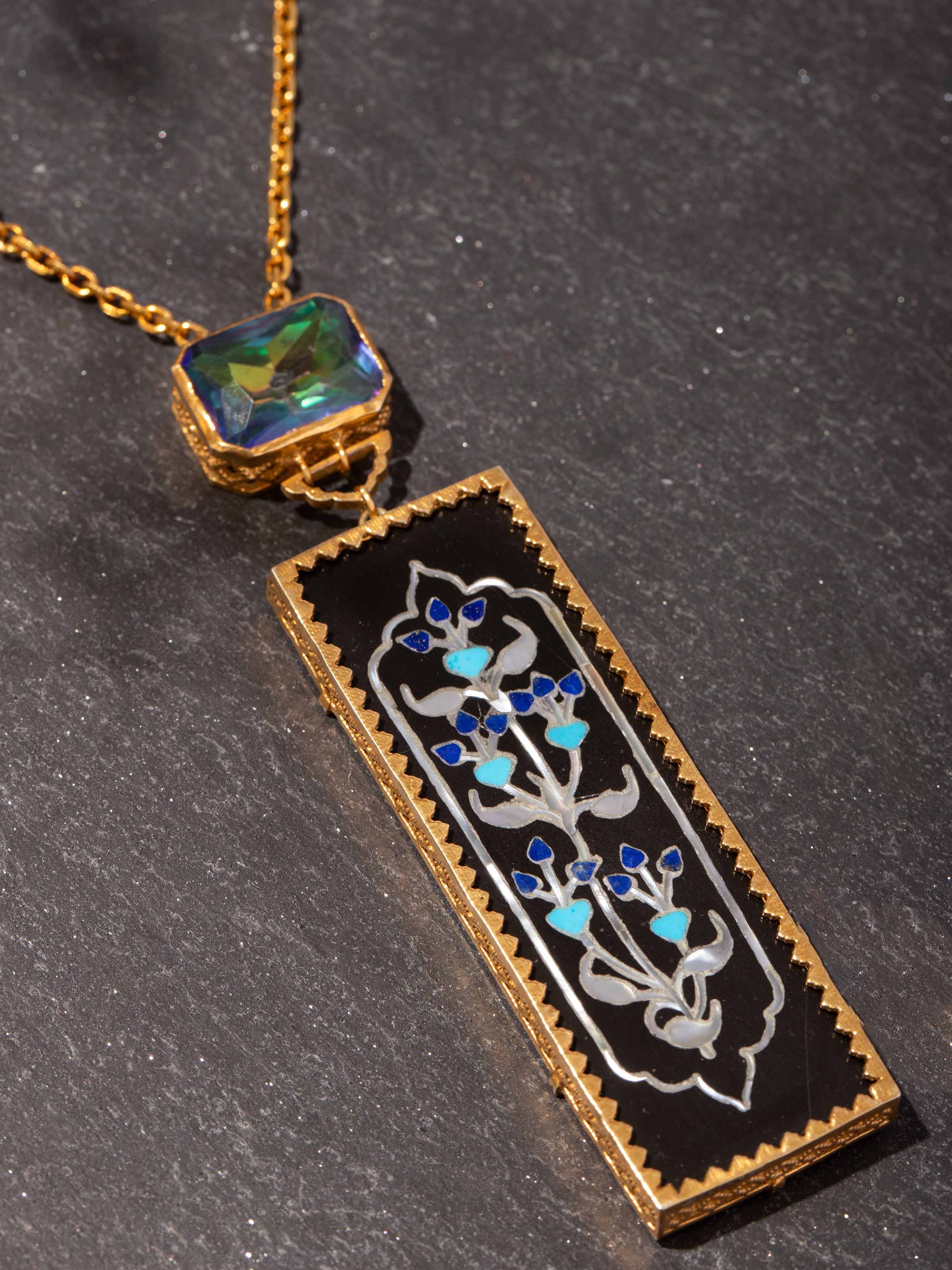 Detail shot of silver pendant highlighting engraved surface and loop attachment