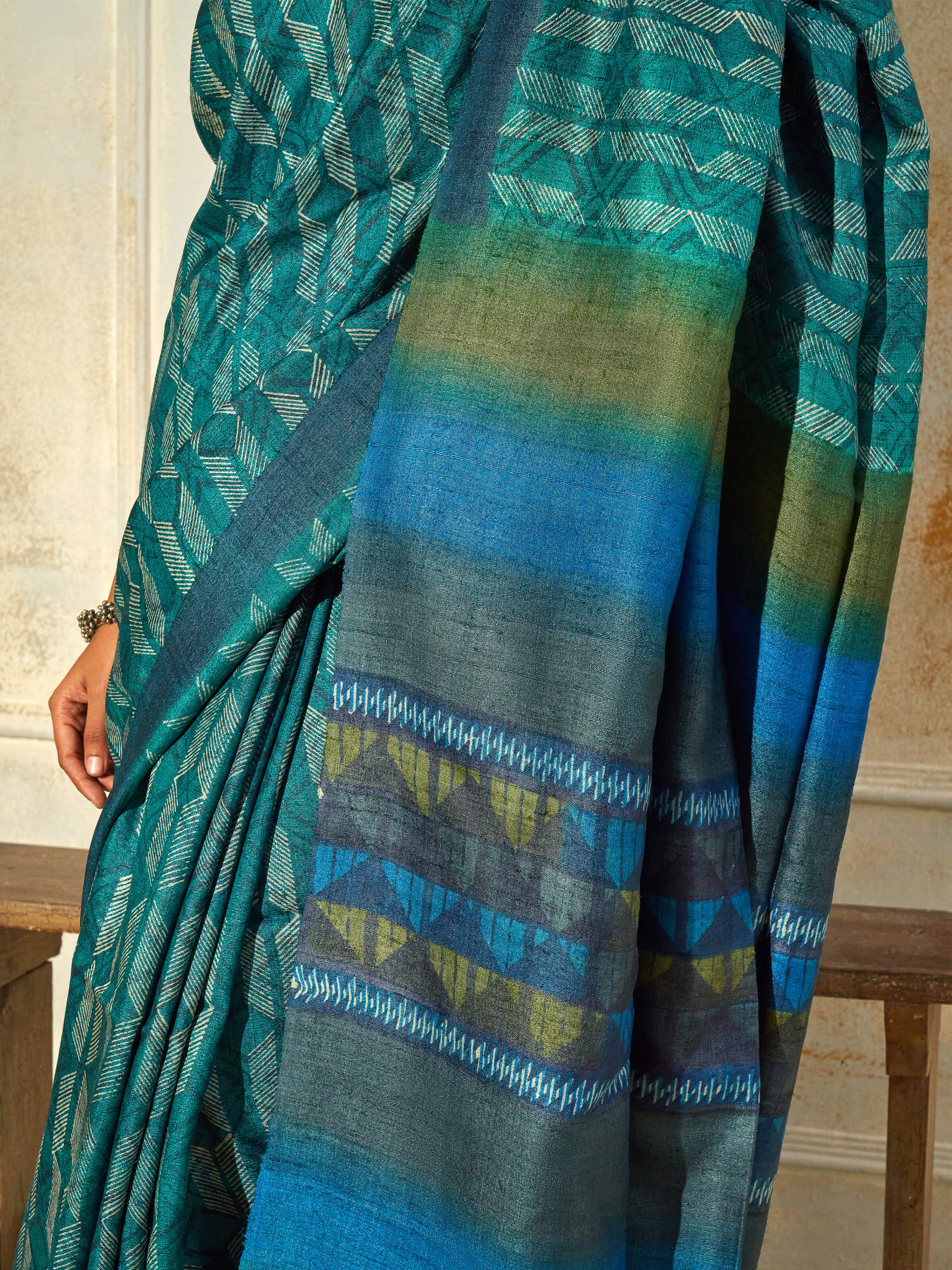 Detail view of sea green tussar silk discharge block printed saree showing fabric texture