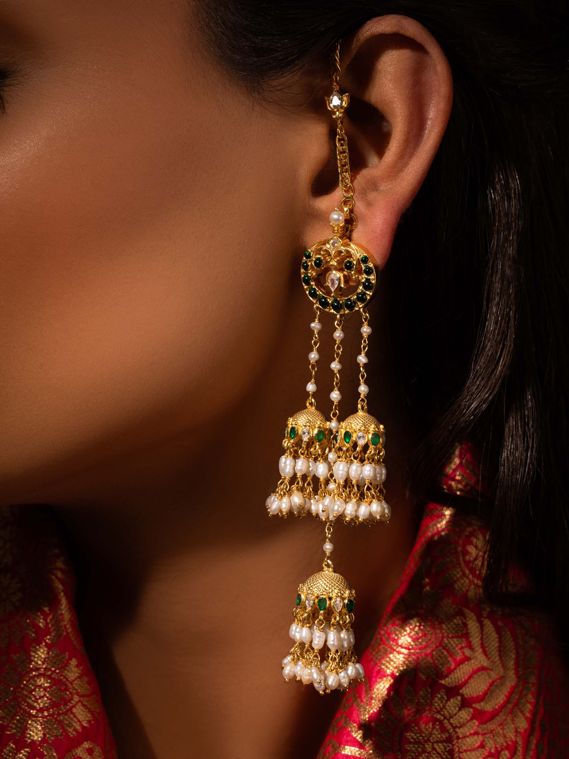 Detailed shot focusing on fine silver work and patterns of the earrings