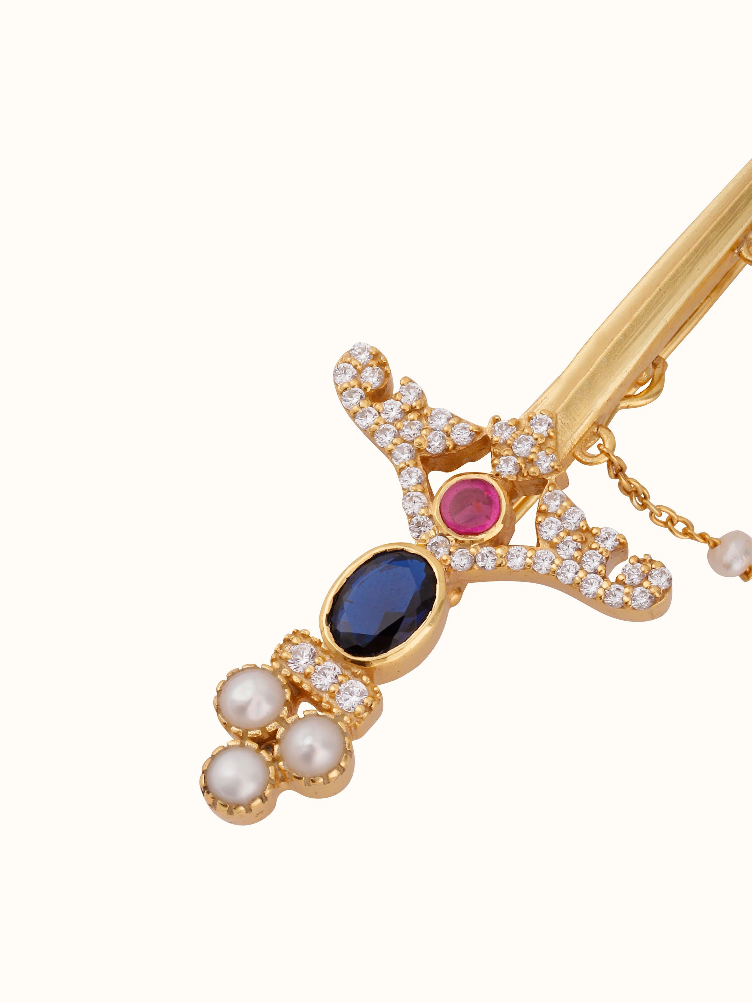 Overhead view of silver smithing lapel pin laid flat to reveal shape and craftsmanship