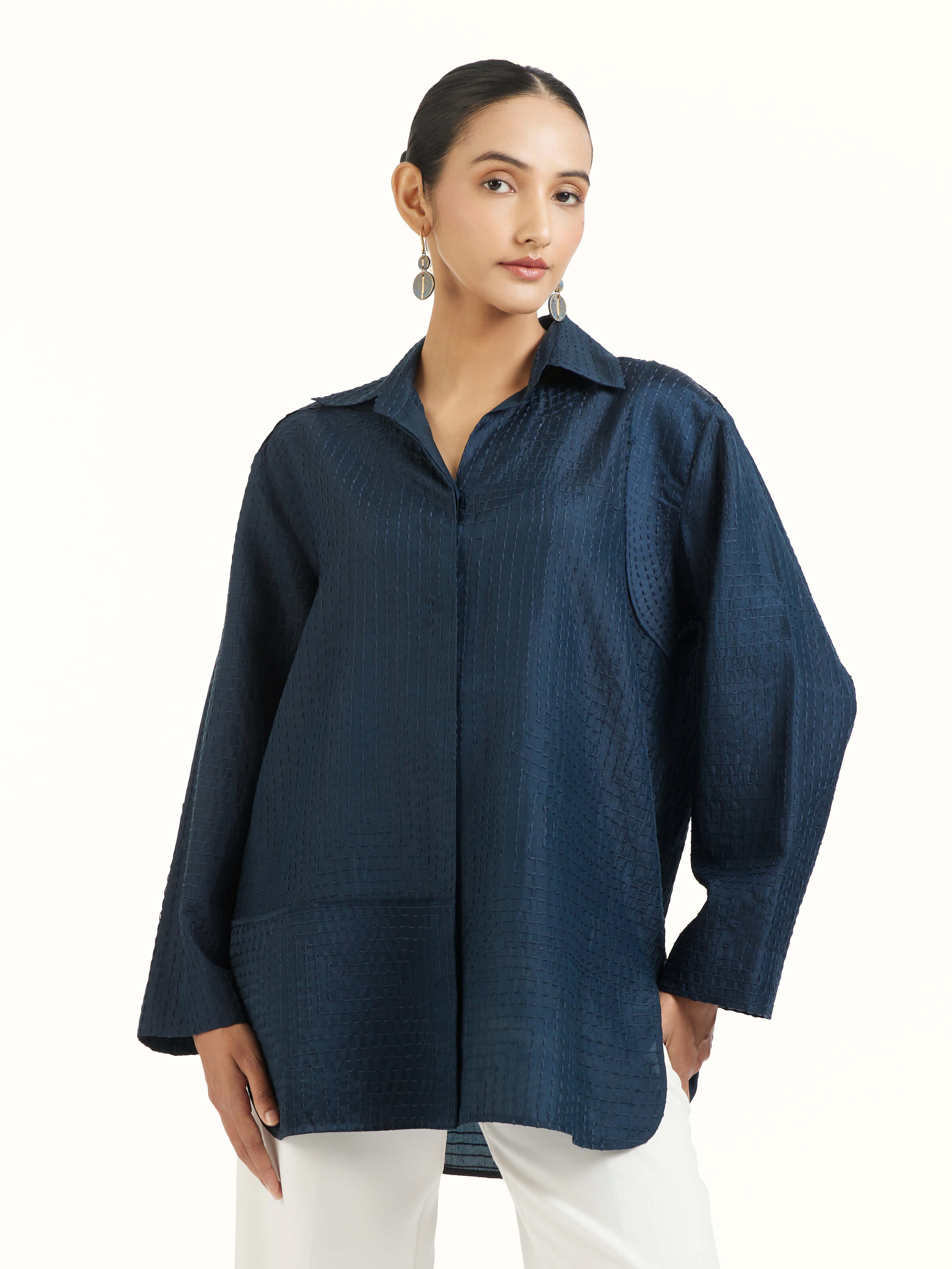 Angled view of blue silk kantha shirt emphasizing embroidery and silk sheen