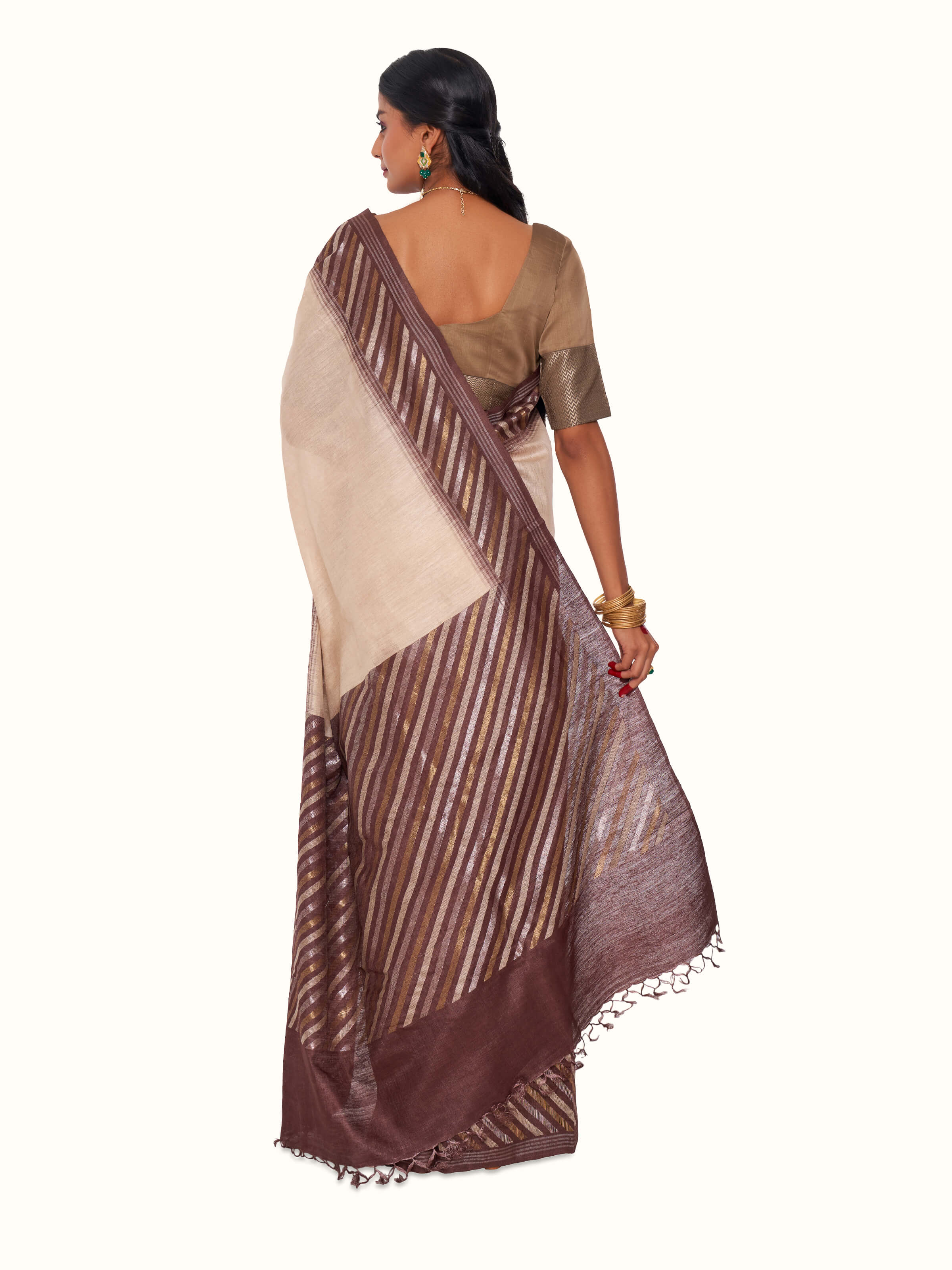 Back view of beige tussar muga silk saree displaying pallu design