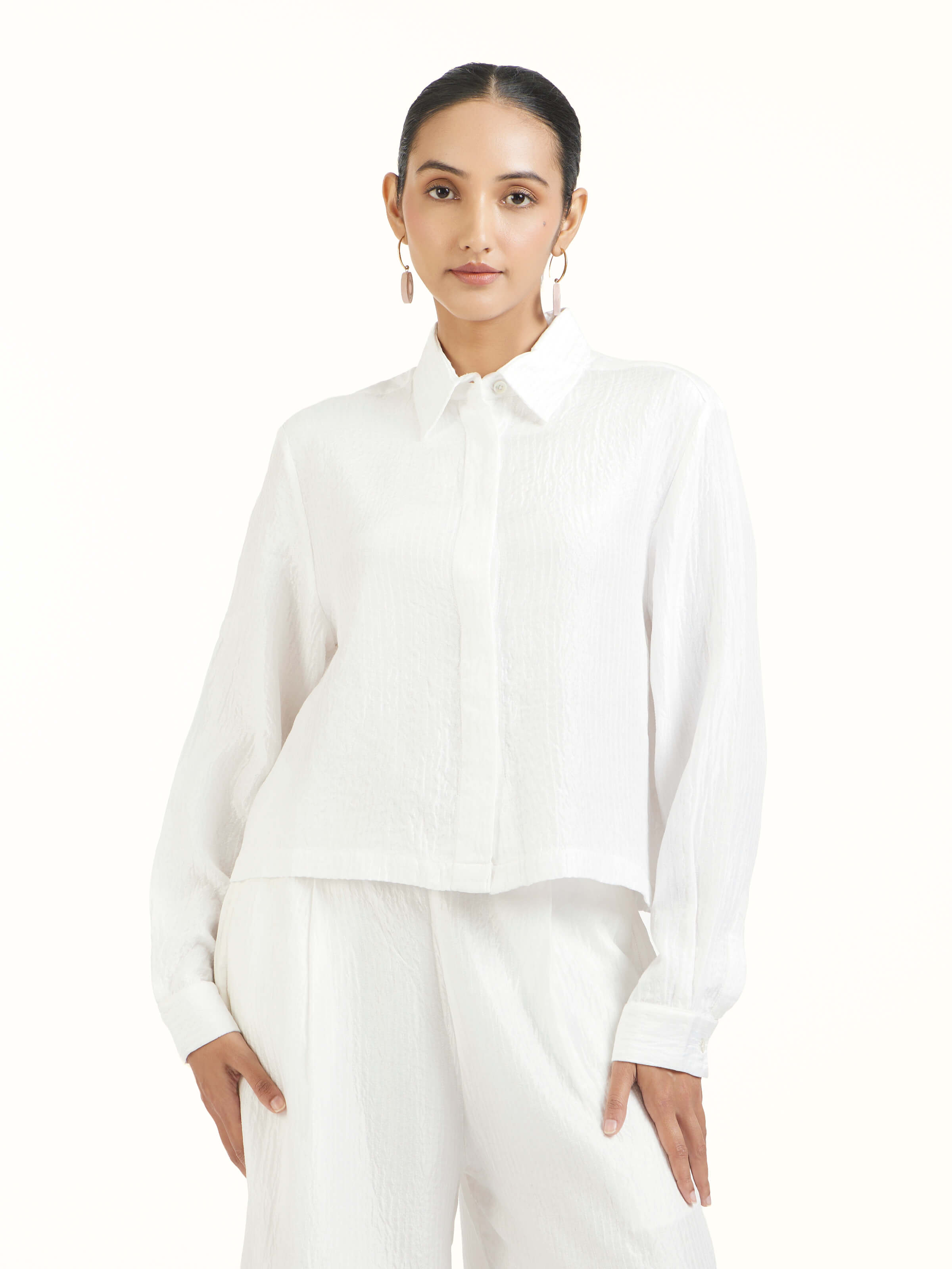 Angled view of ivory quilted silk shirt highlighting quilted detailing