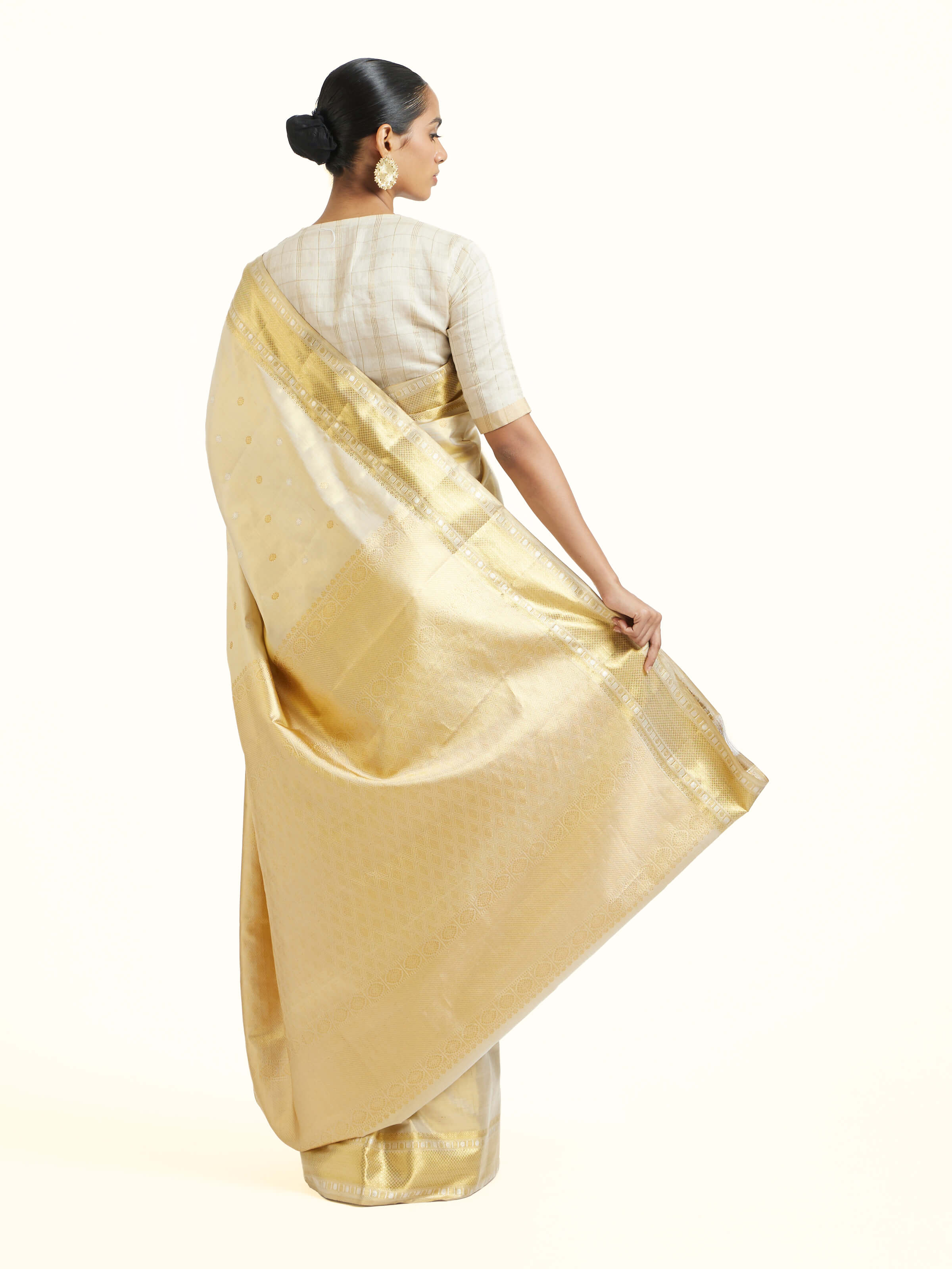 Back view of beige silk Kancheepuram saree displaying ornate pallu design