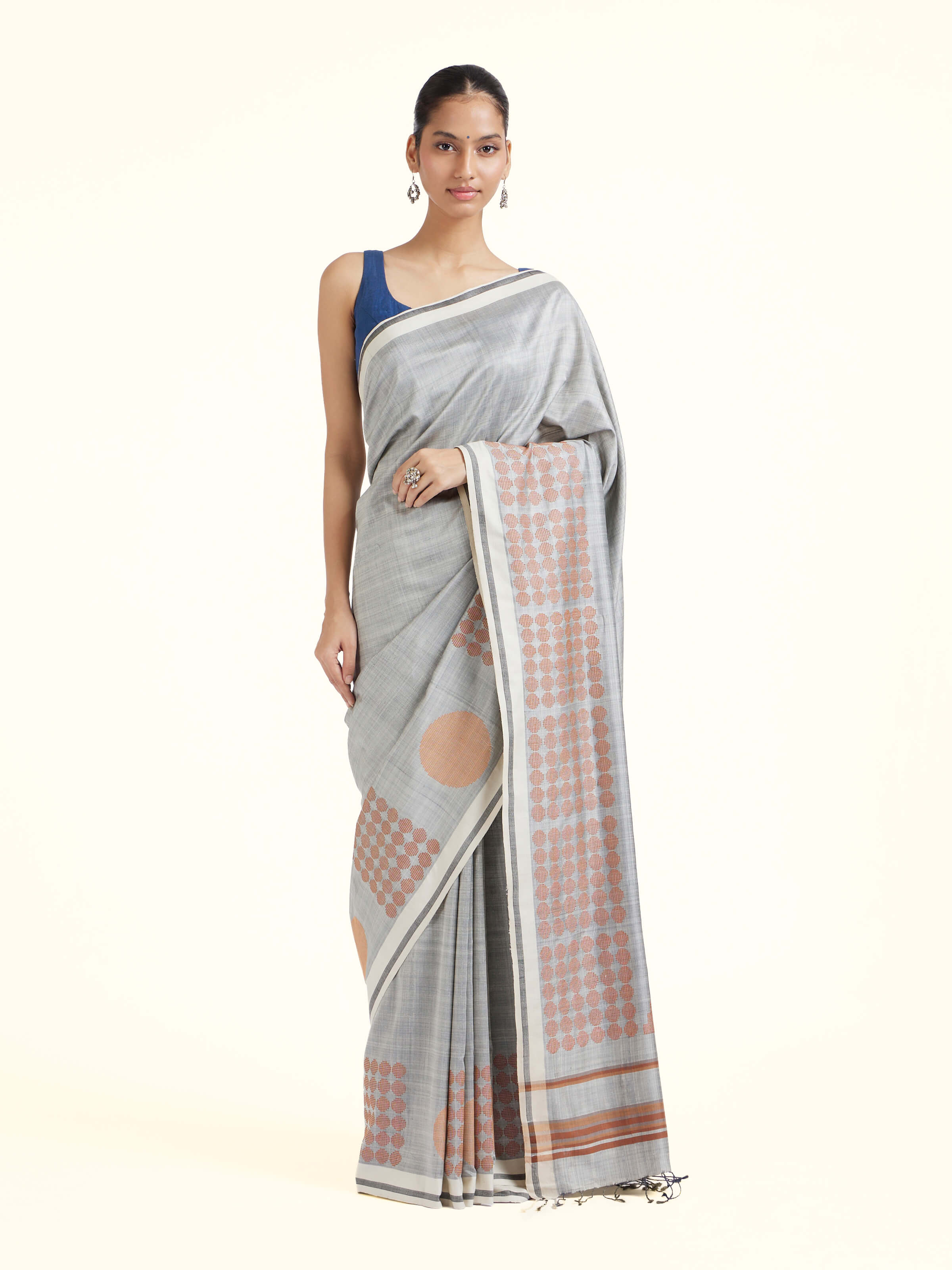 Front view of grey silk extra-weft saree showcasing rich woven motifs