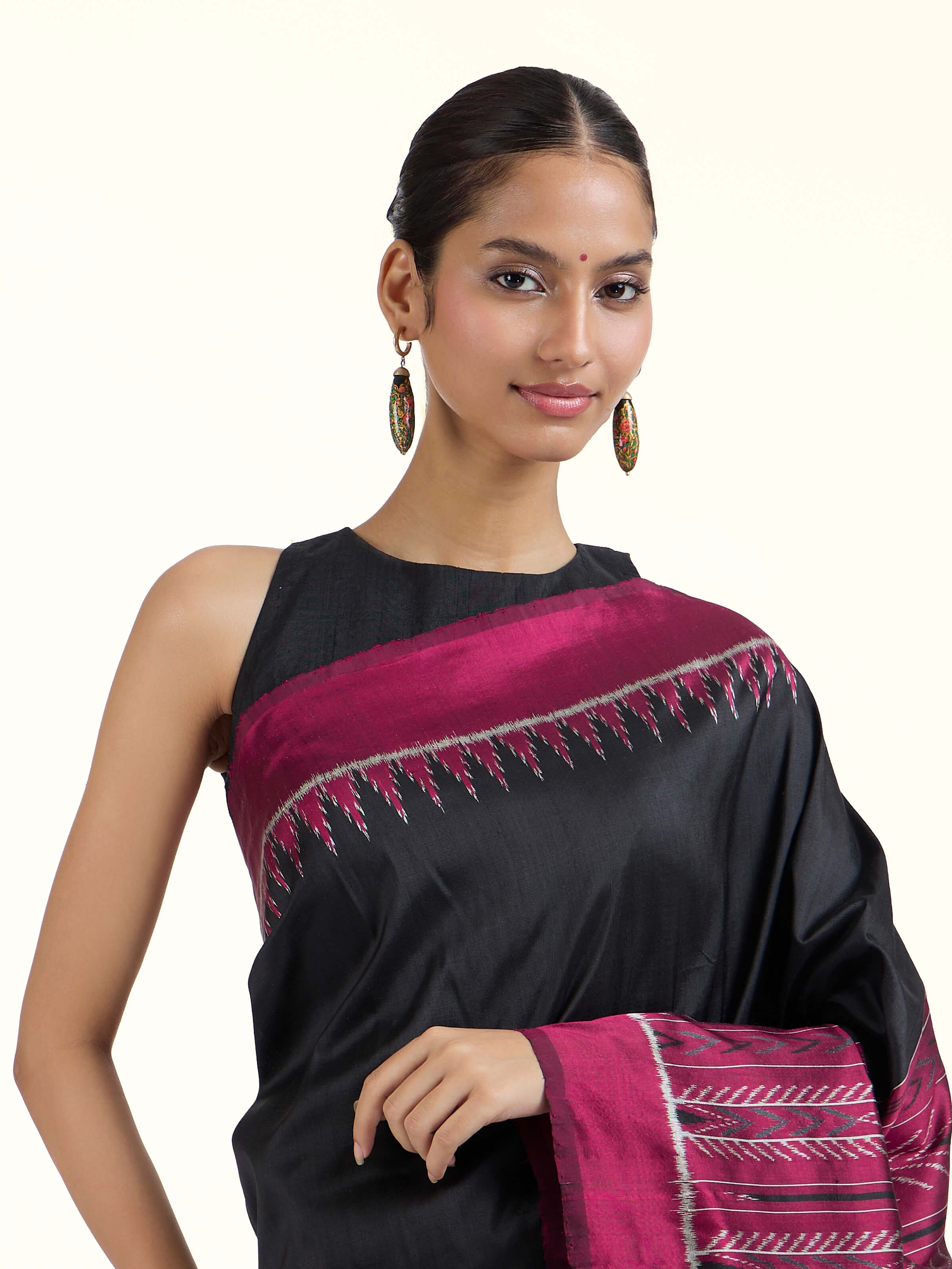 Angled view of black mulberry silk Odisha ikat bandha saree emphasizing bandha technique