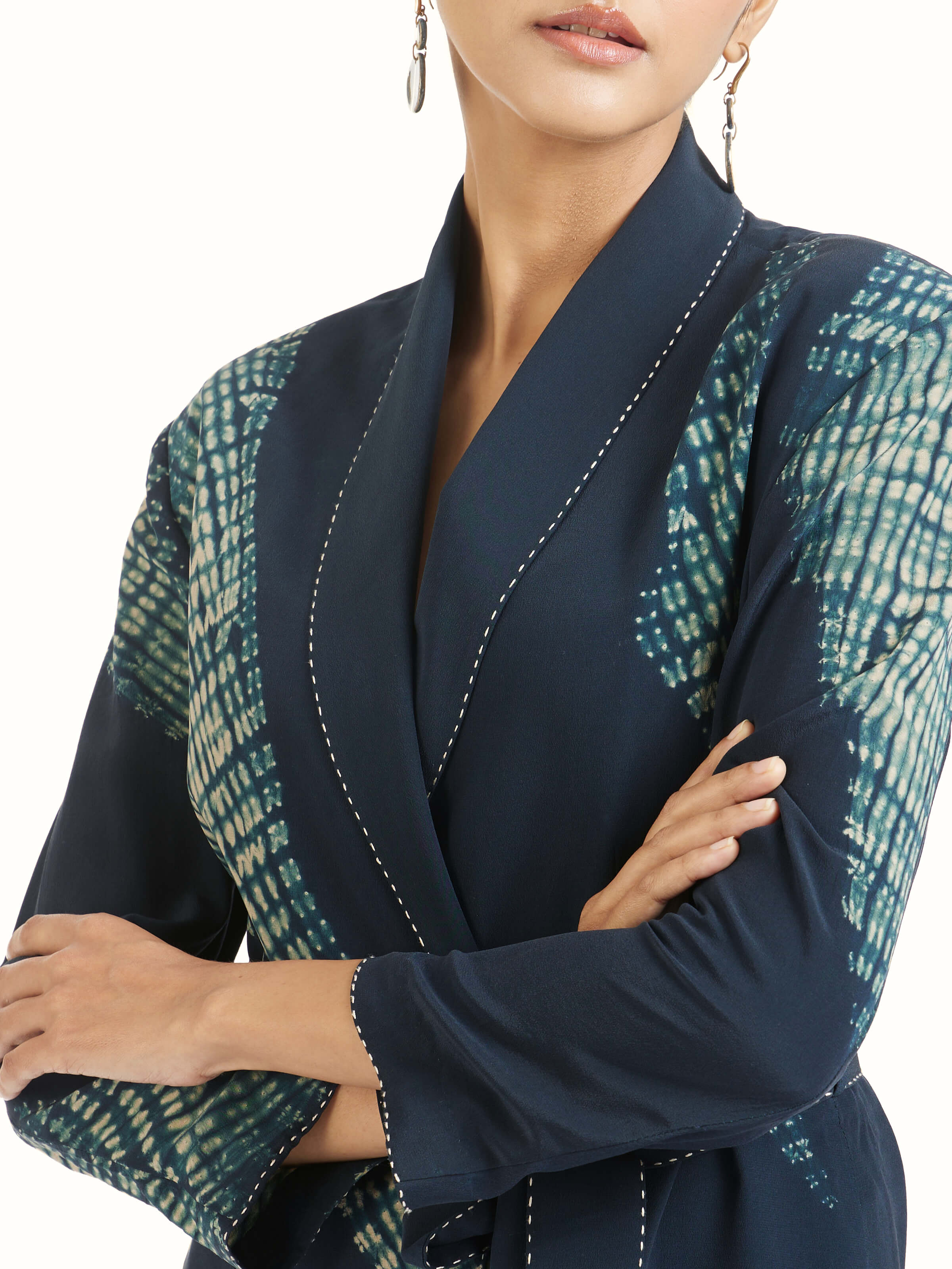 Detail view of blue shibori jacket dress showing fabric texture and dye technique