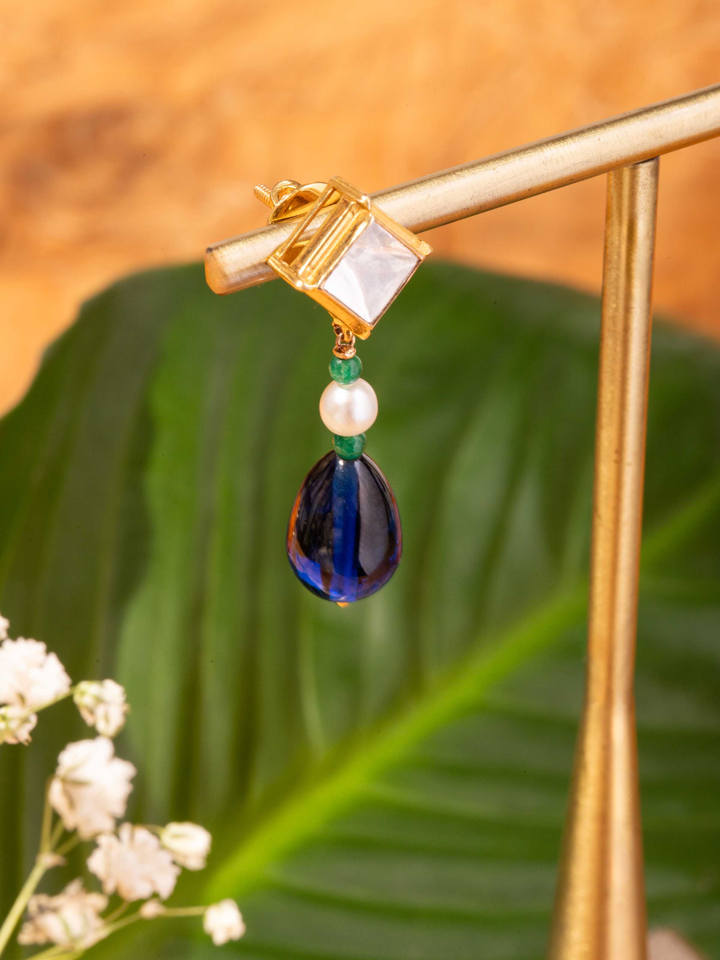 Alternate lifestyle view of Dank Polki gold earrings showing drop length and traditional detailing.