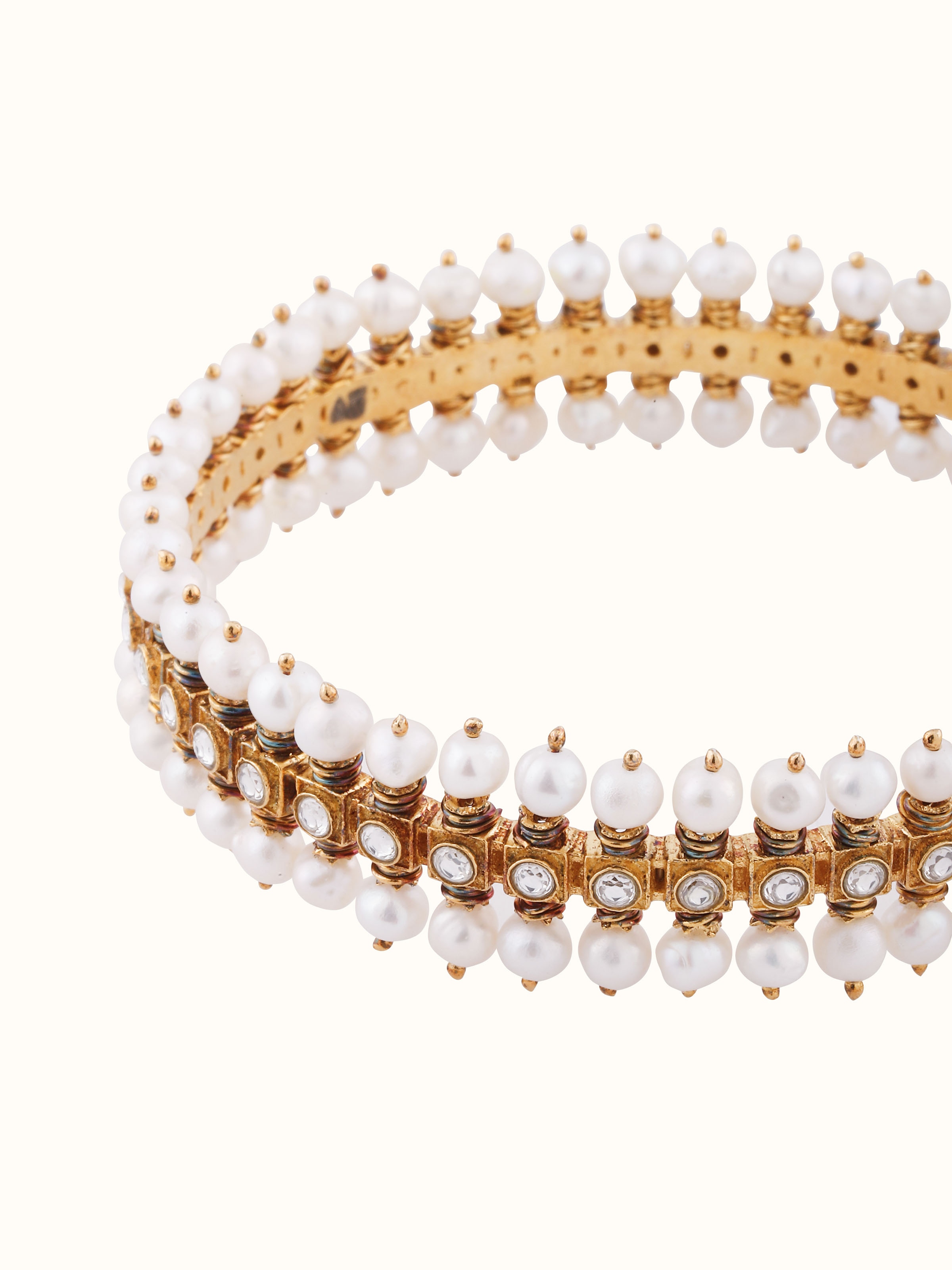 Overhead view highlighting the bangle’s circular structure and ornamental design.
