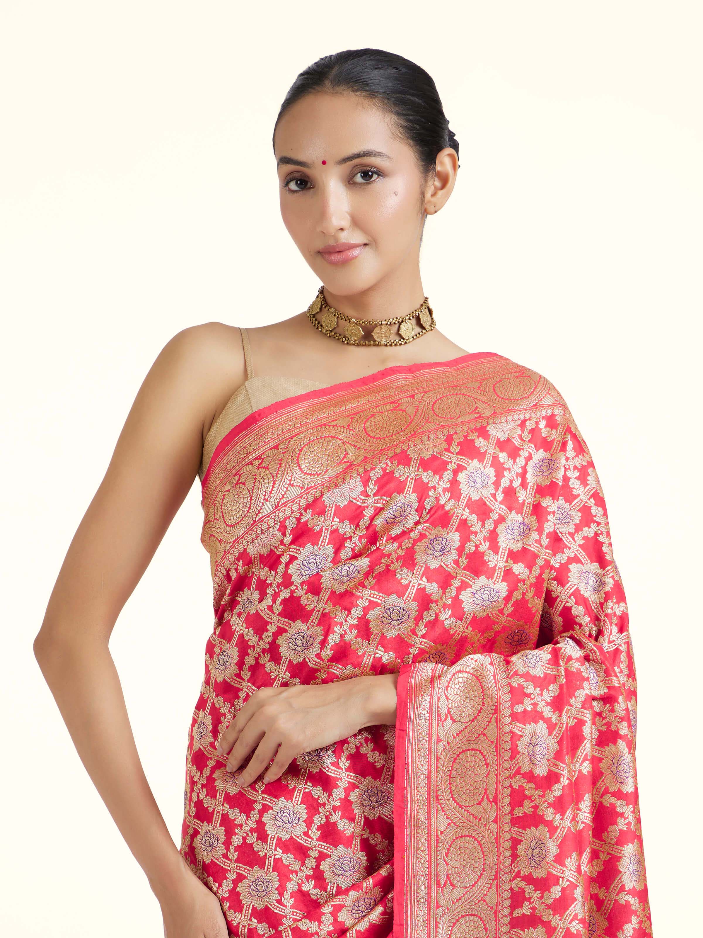 Angled view of red mulberry katan silk Banarasi saree showcasing traditional design