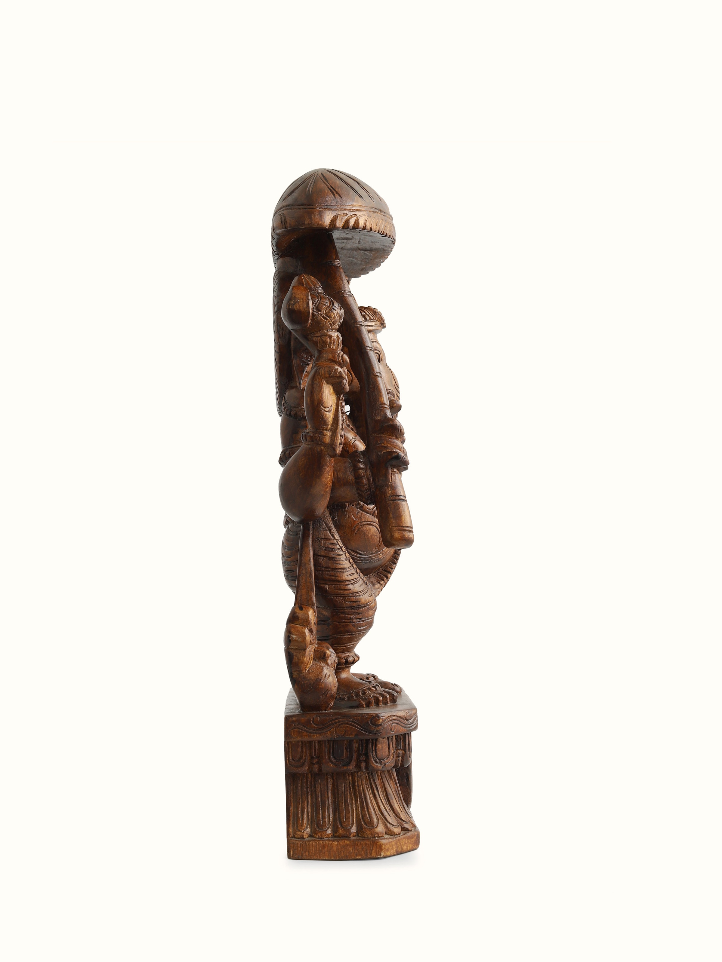 Side view of Carved Ganesha Idol with Umbrella, emphasizing the graceful profile and handcrafted wooden textures.