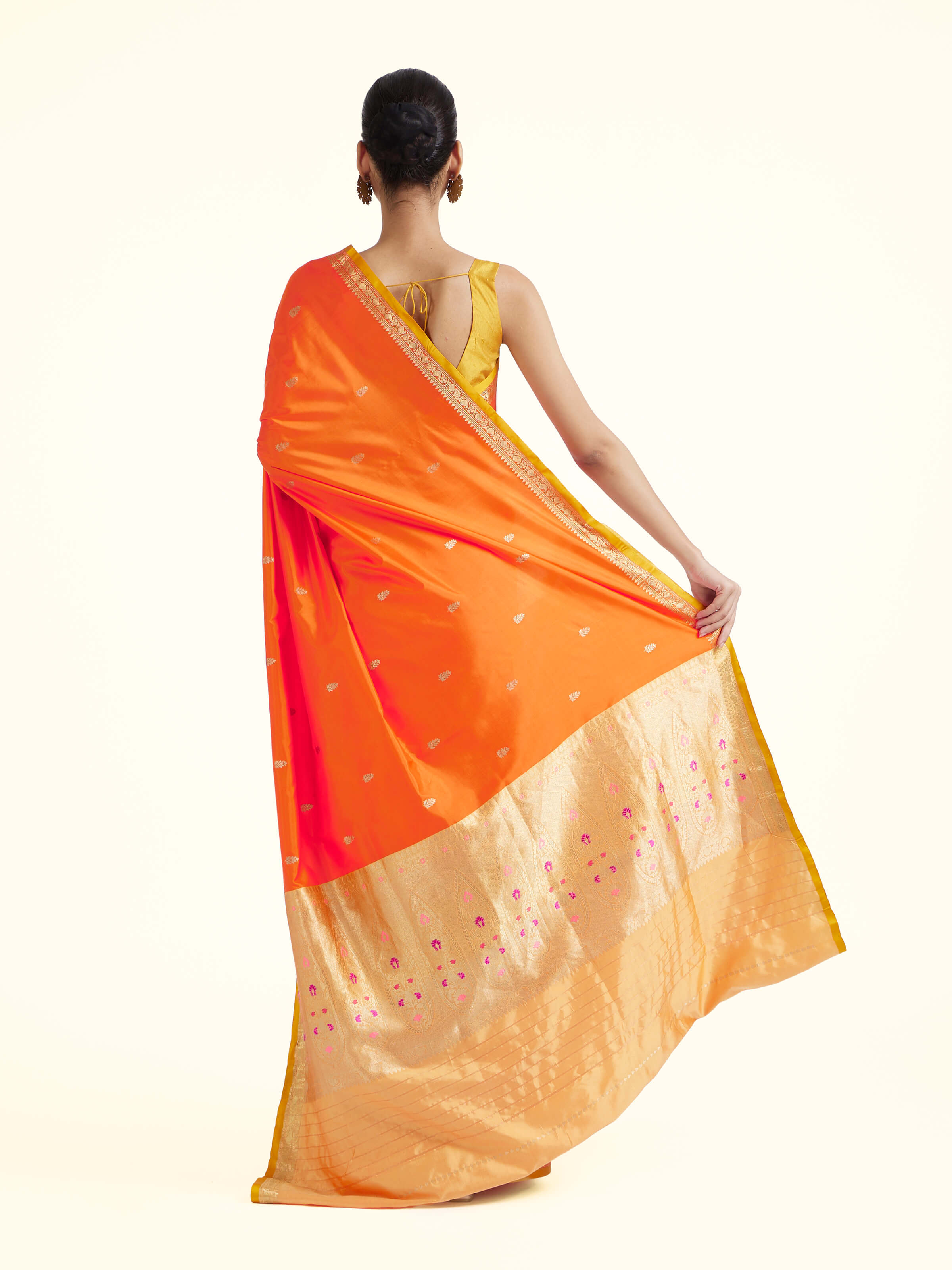 Back view of orange mulberry katan silk Banarasi saree displaying ornate pallu design