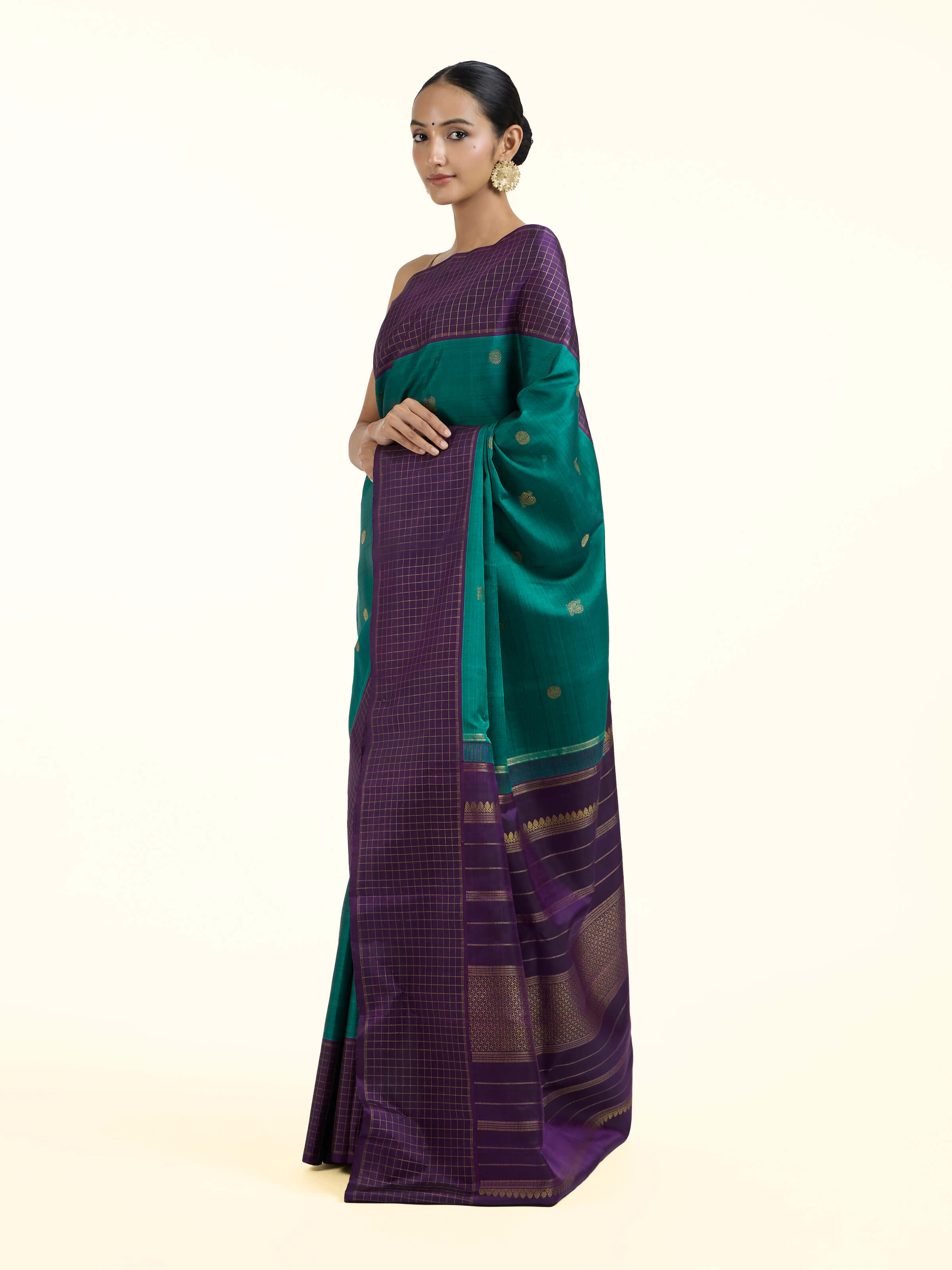 Side view of green silk Kancheepuram saree highlighting drape and silk texture