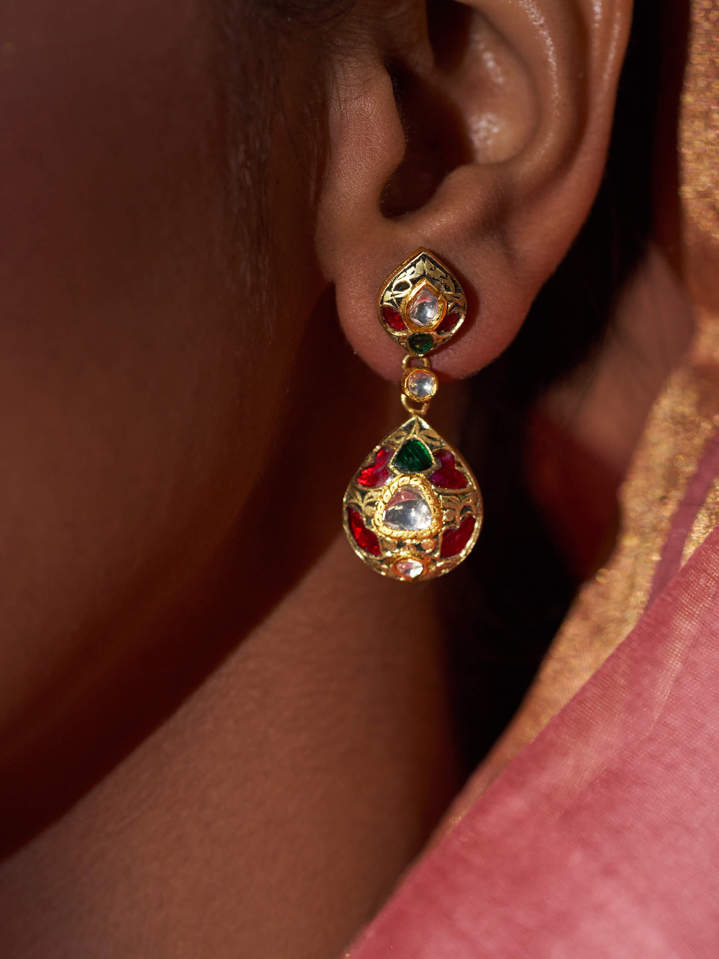 Angled view of Partash 18 Karat gold drop earrings with elegant finish