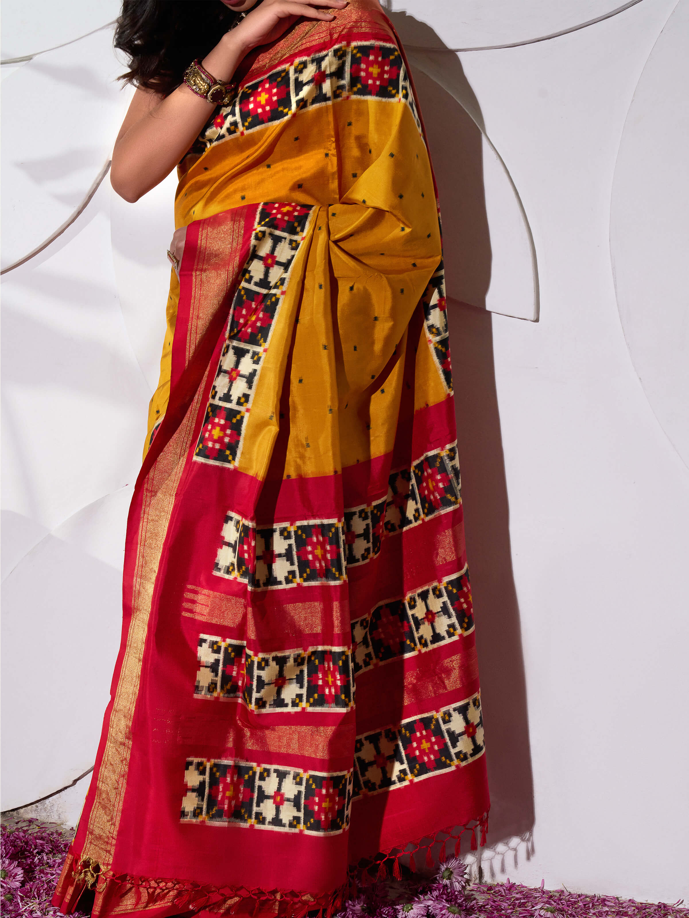 Detail view of yellow silk Pochampally double ikat saree showing ikat weave