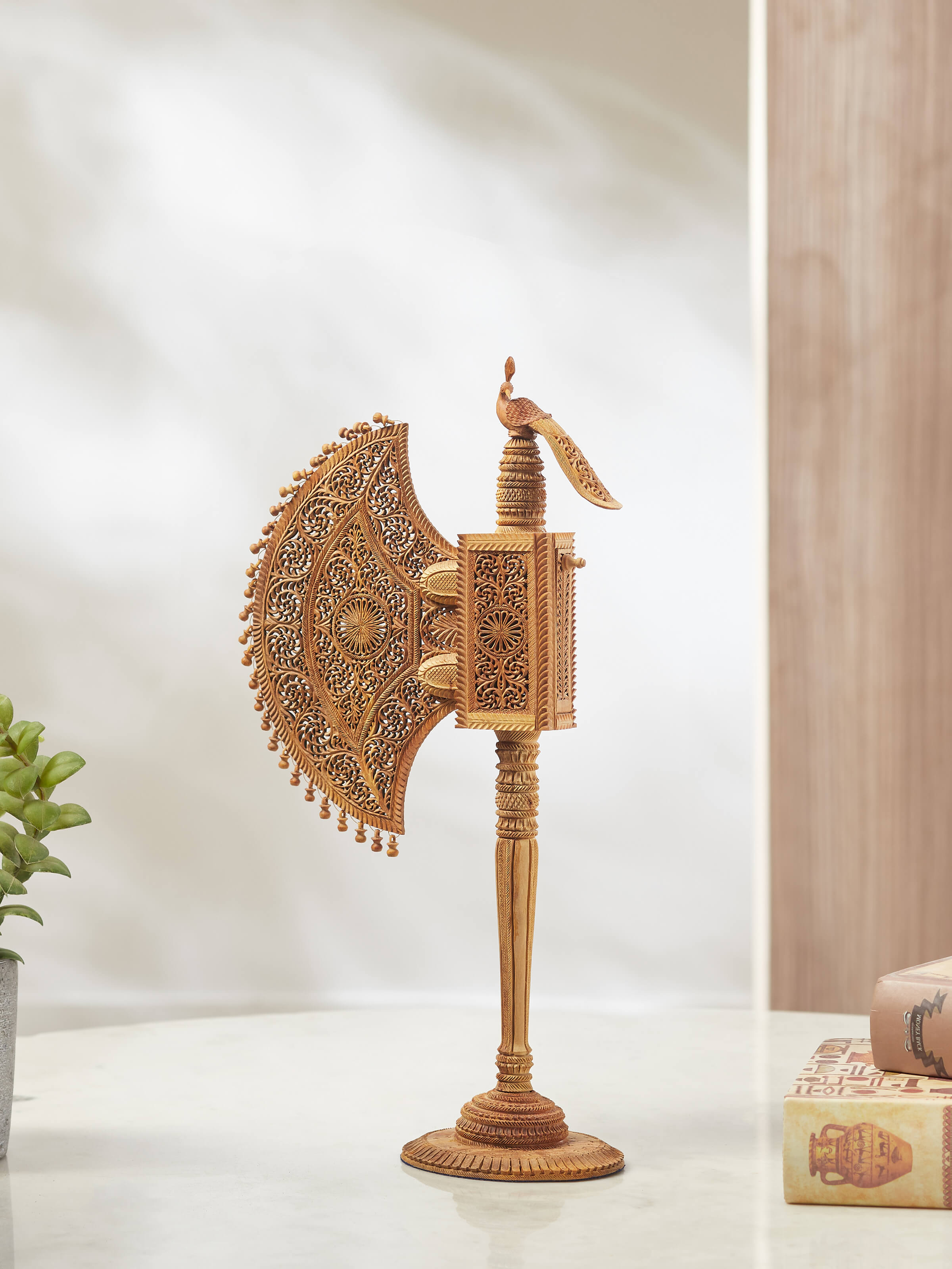 Side view of Bilara carved sandalwood jaali fan sculpture highlighting detailed work