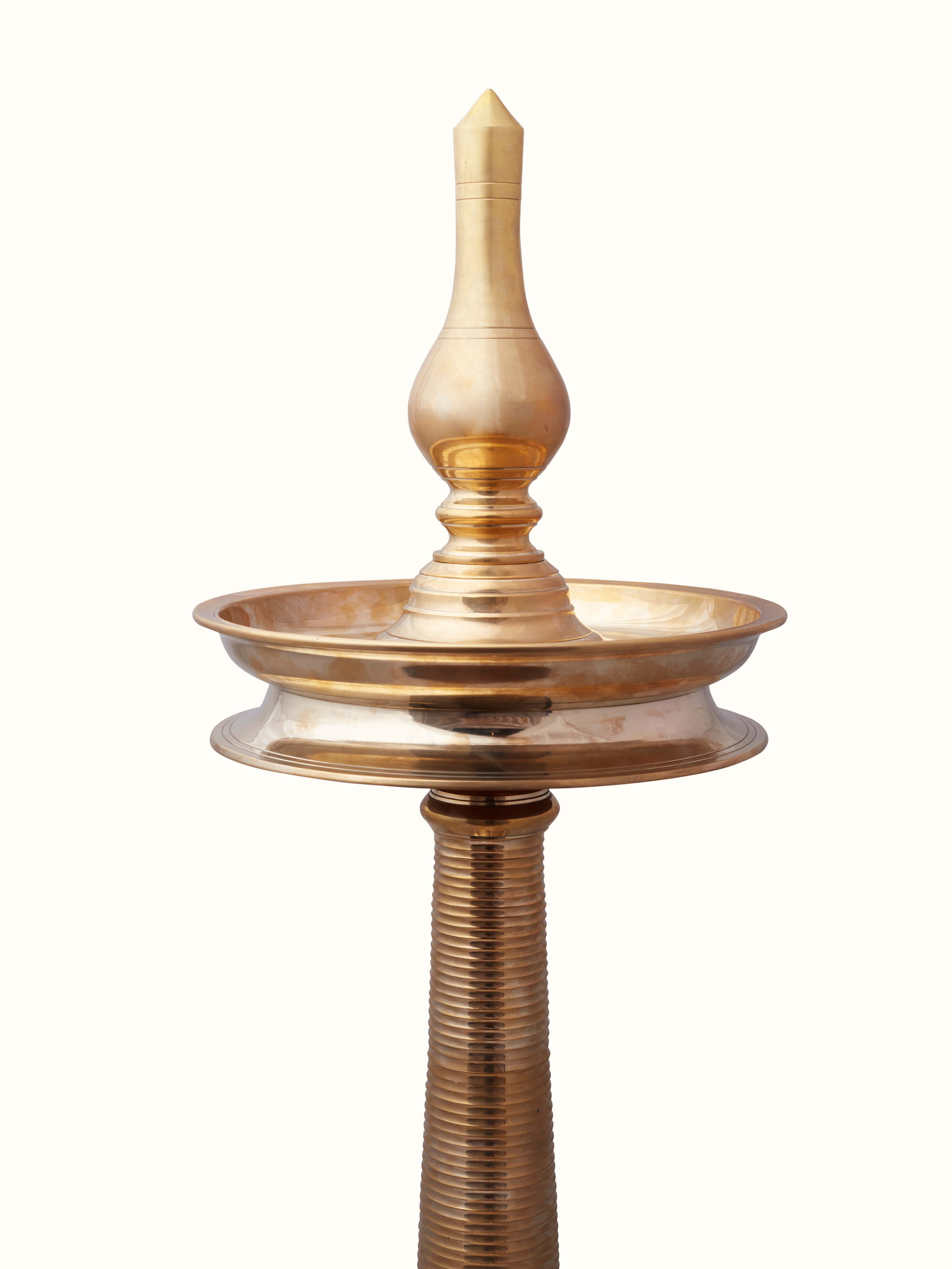 Side view of Vilakku brass stand diya focusing on the detailed craftsmanship