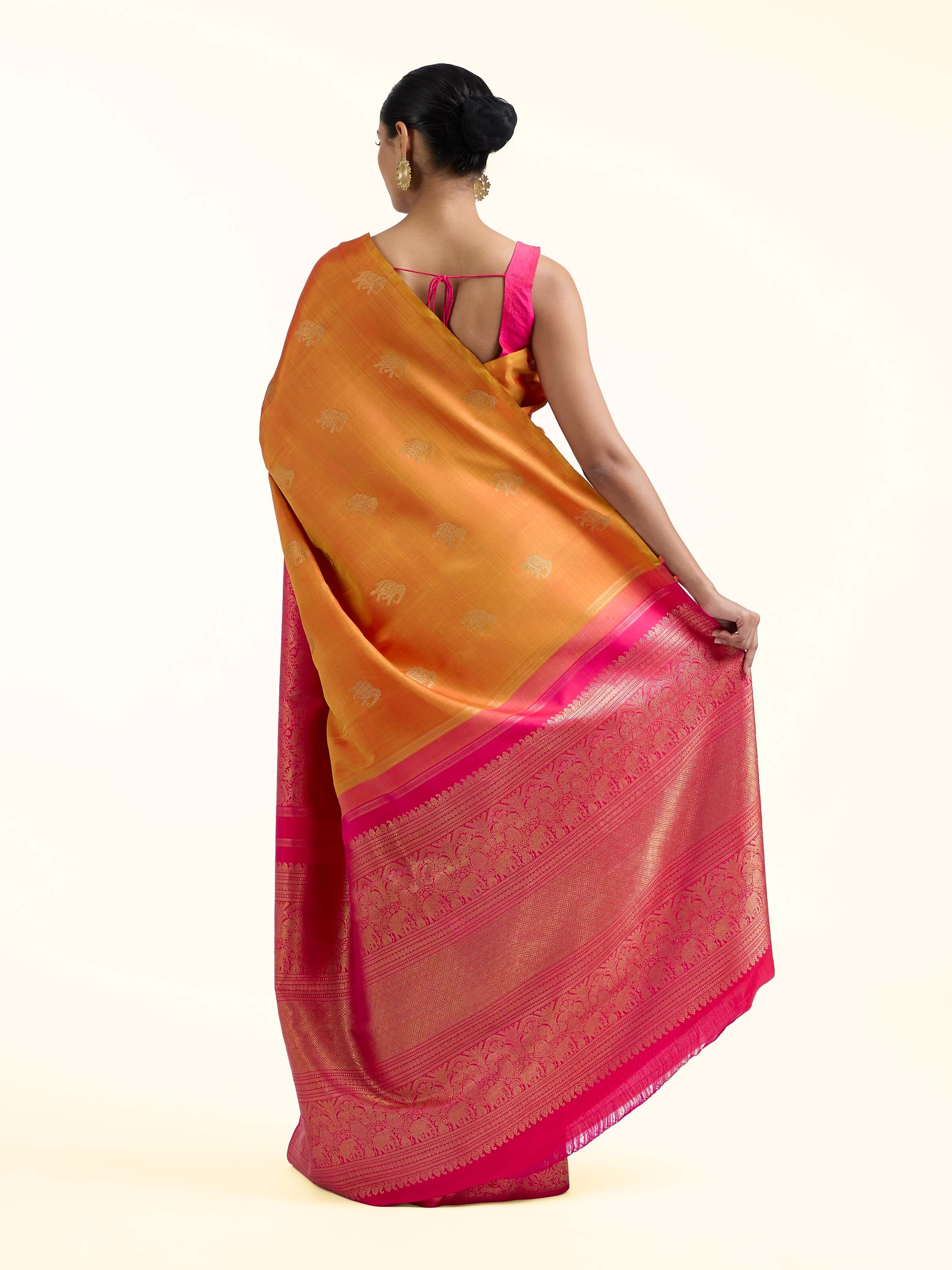 Back view of orange silk Kancheepuram saree displaying grand pallu