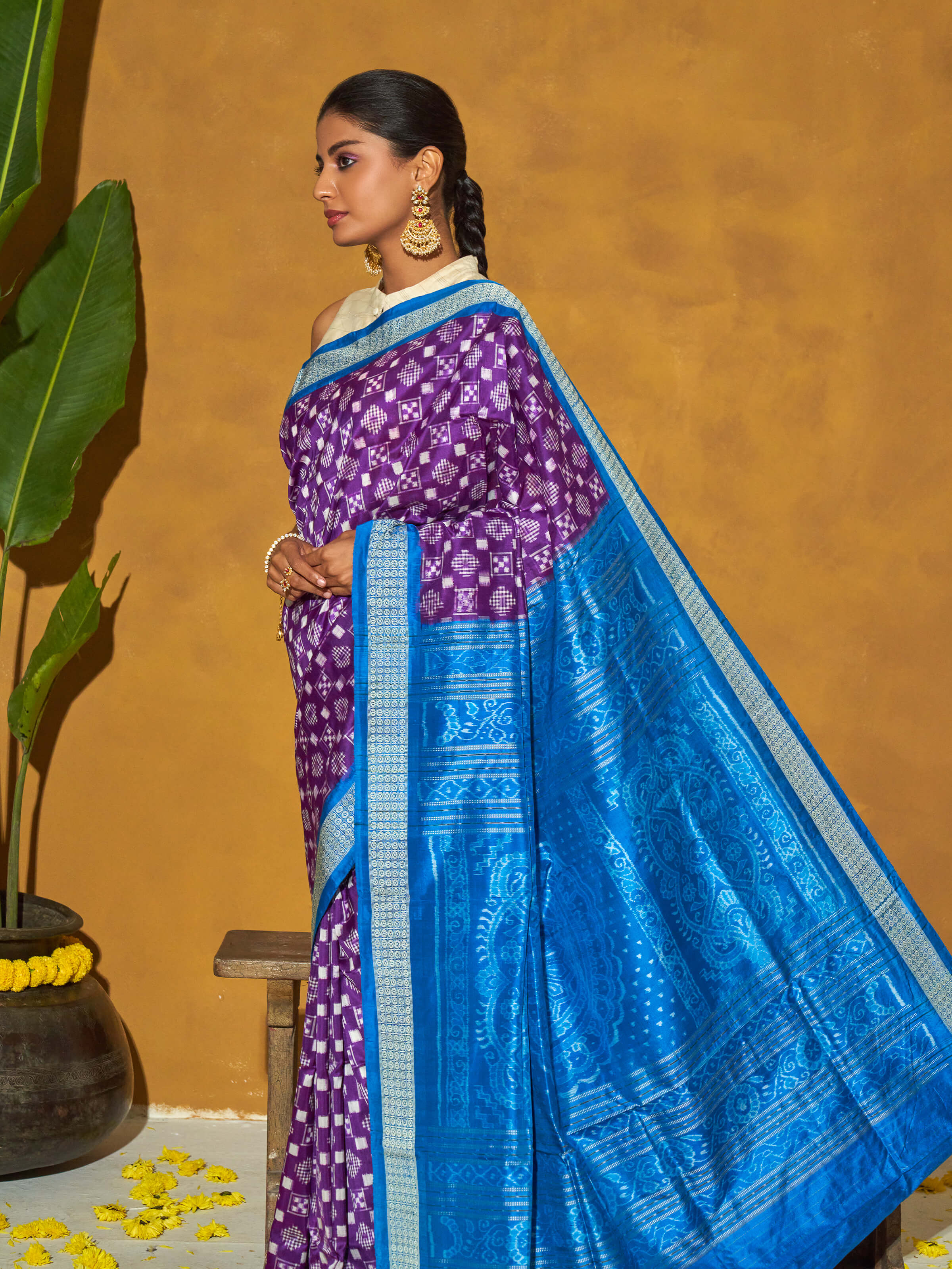 Angled view of turquoise mulberry silk bandha Odisha ikat saree showcasing traditional patterns