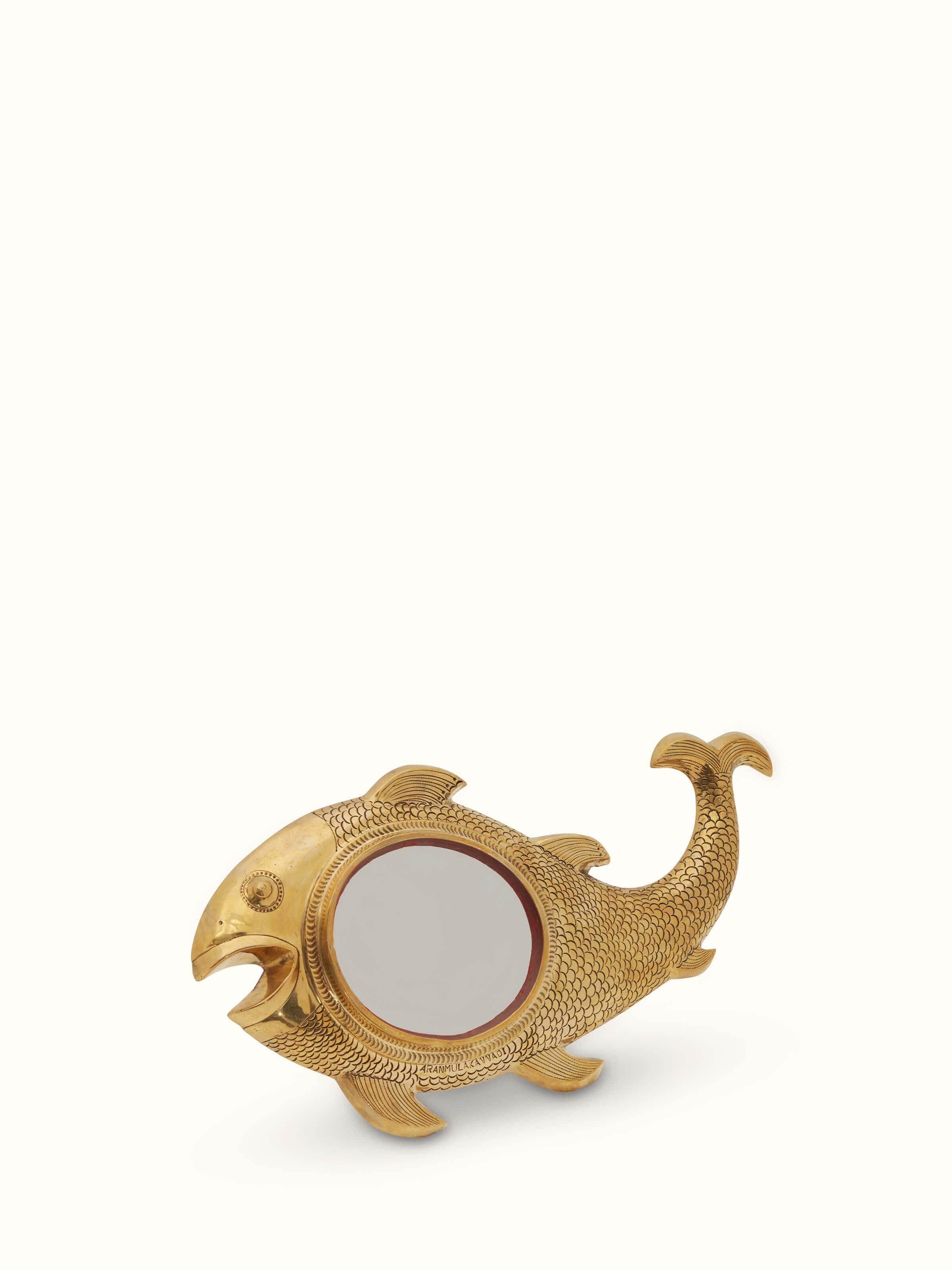 Angled view of Aranmula kannadi brass mirror displaying its elegant craftsmanship.