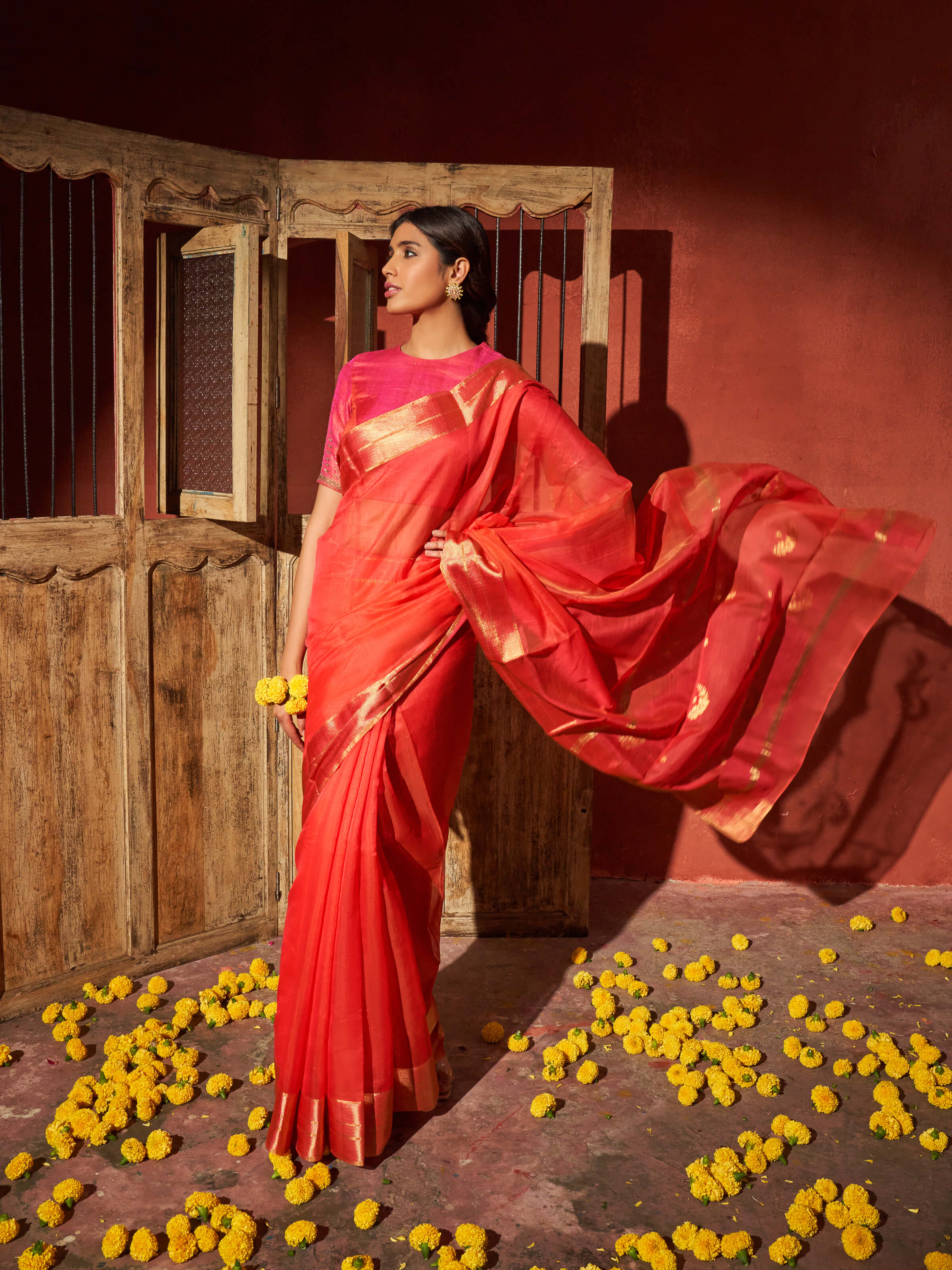Angled view of coral mulberry silk Chanderi saree highlighting subtle patterns