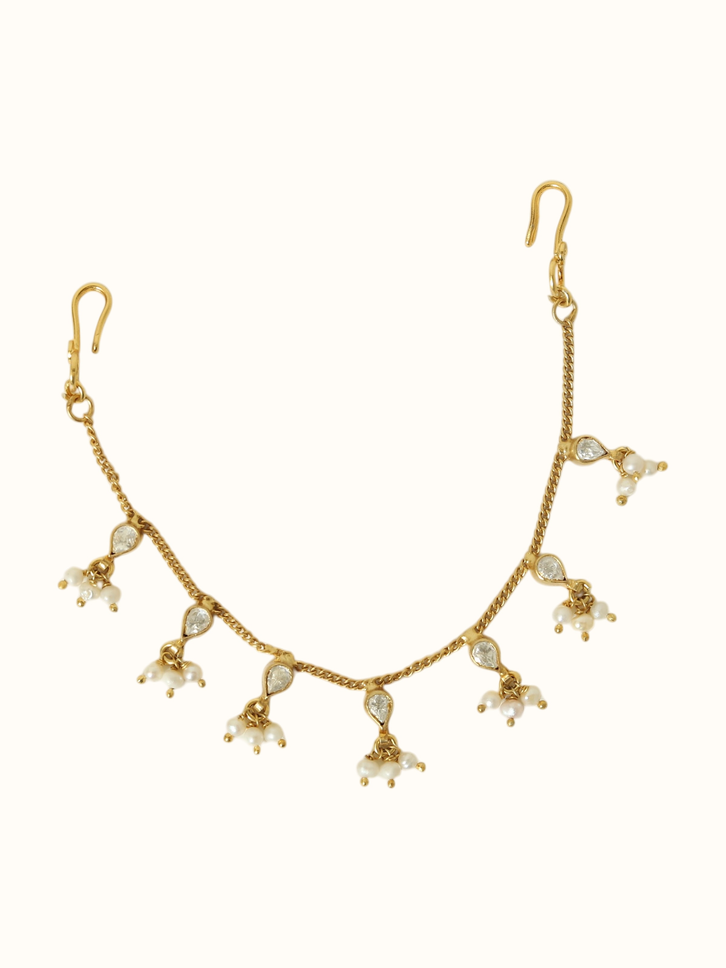 detail view of silver smithing gold plated ear chain chainwork