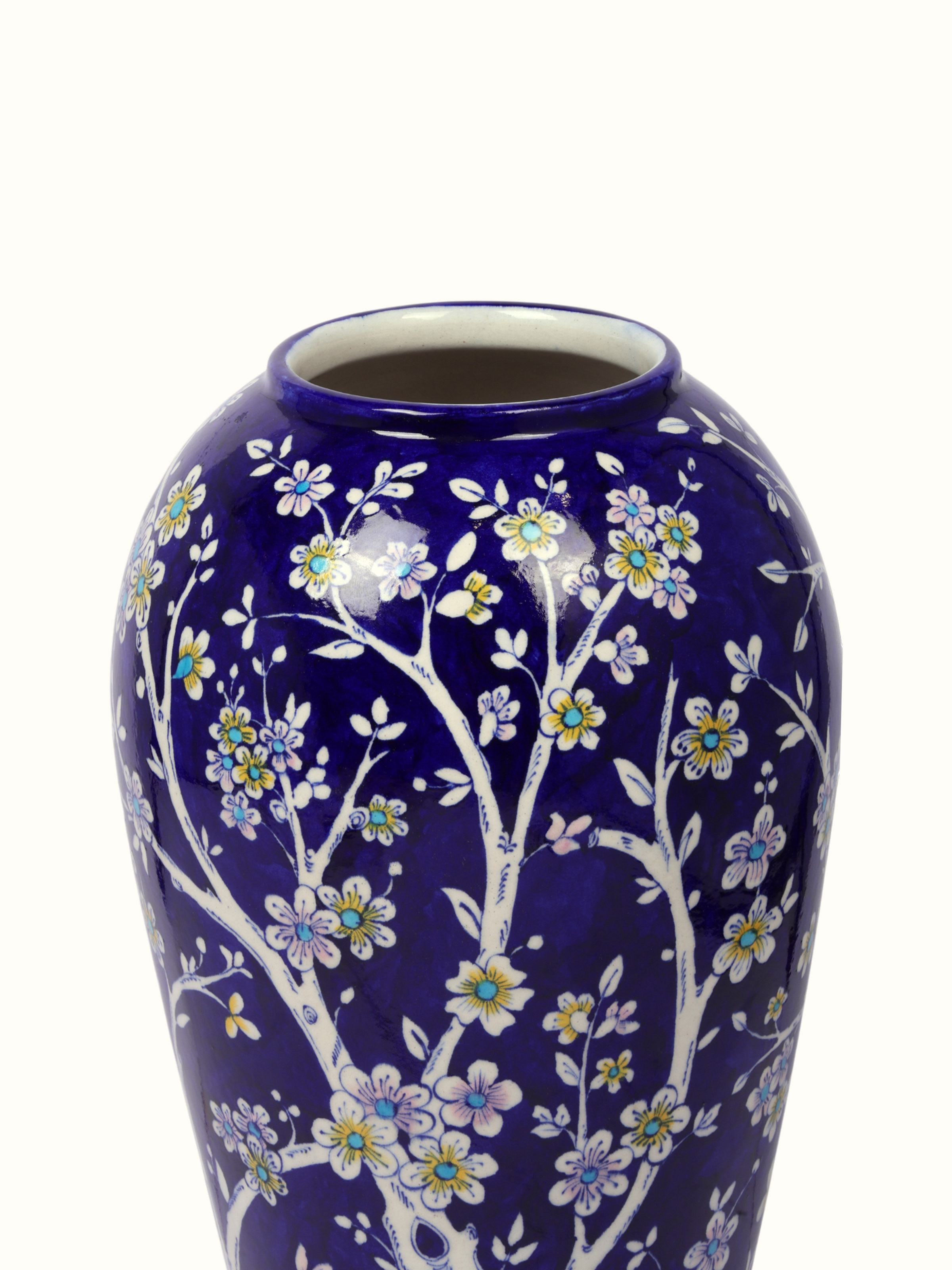 Detail close-up of blue pottery ceramic table vase showing glaze and artwork