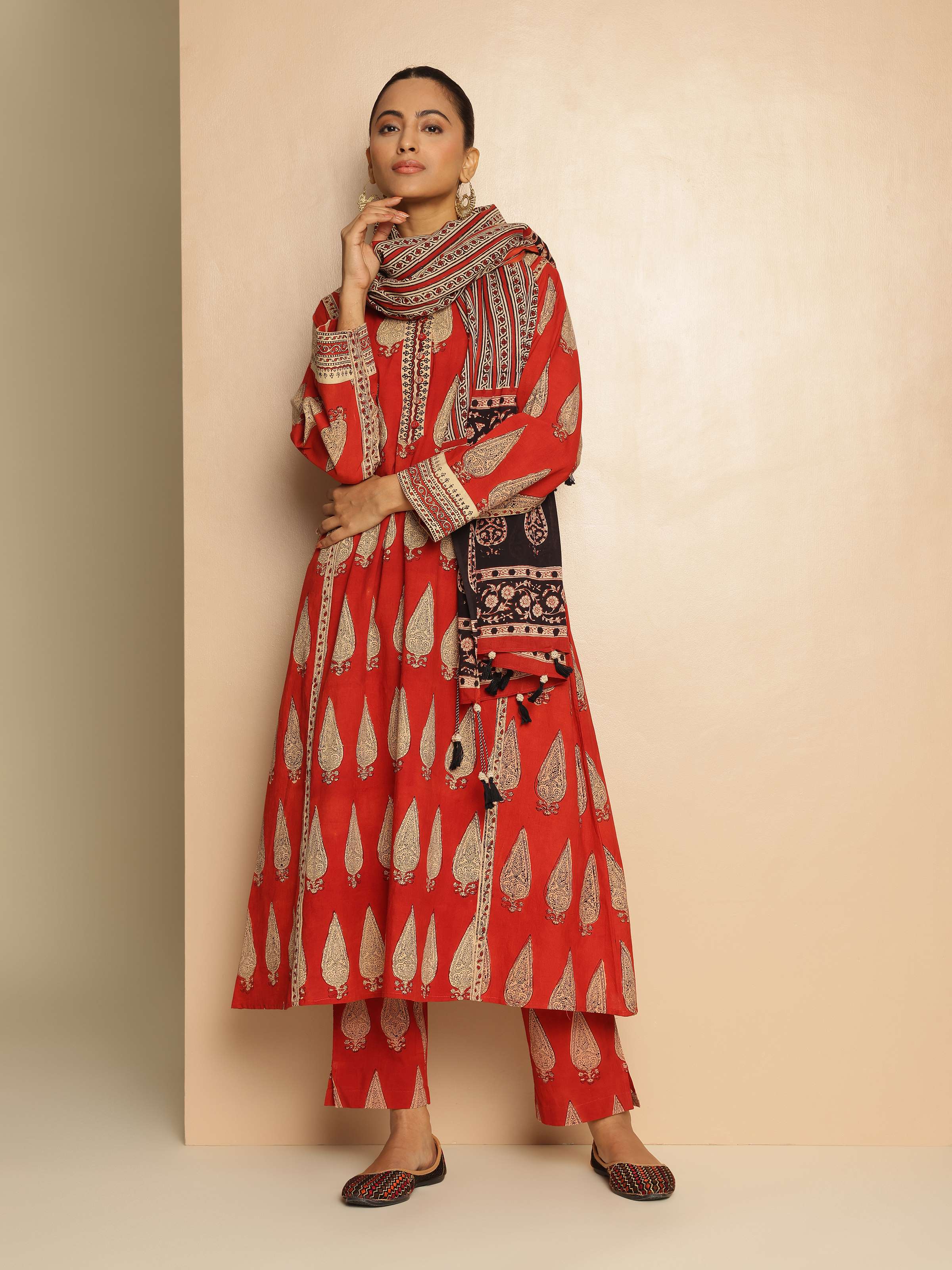 Lifestyle view of red Bagru block printed cotton pant styled casually