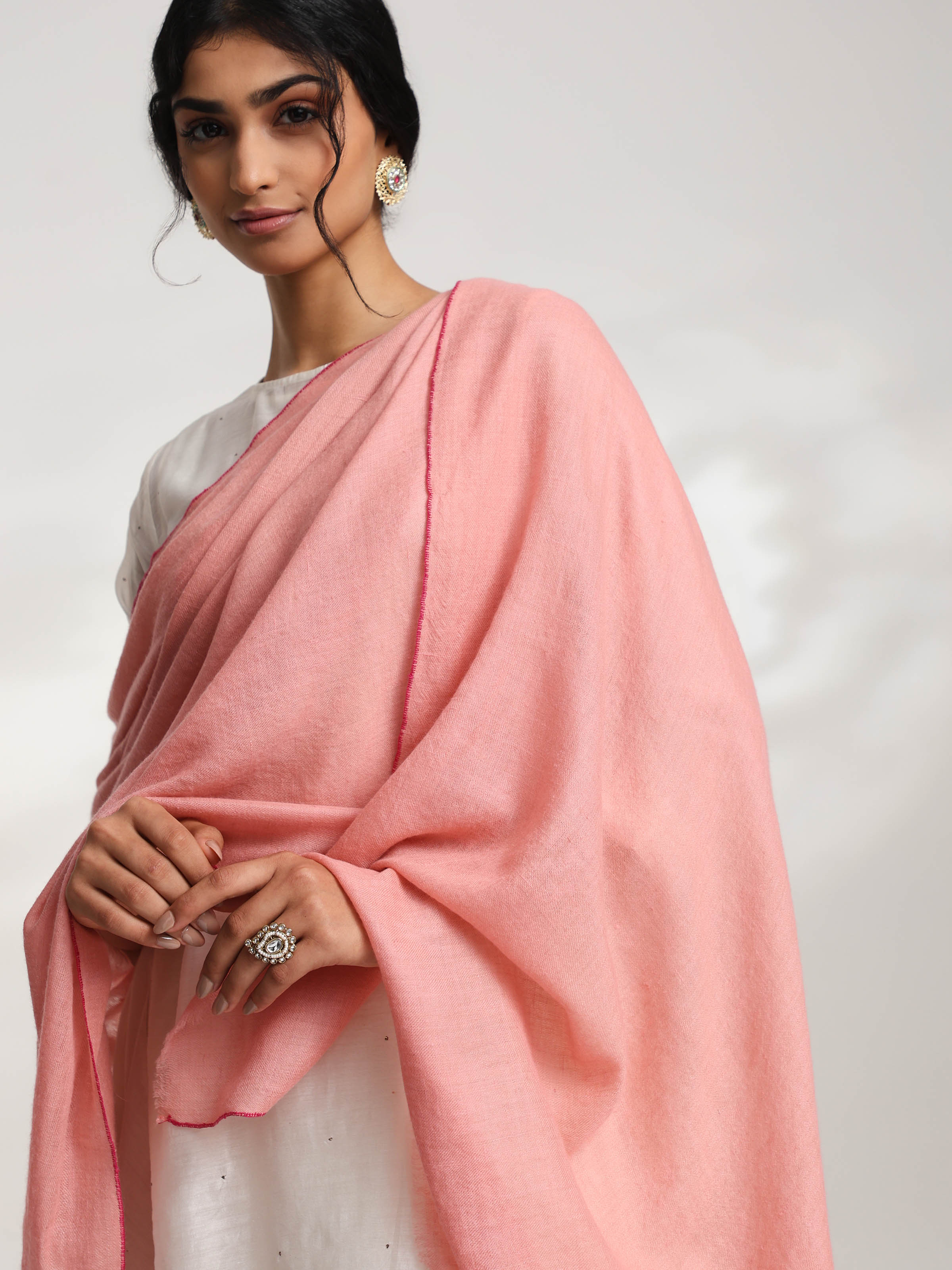 Detail view of pink cashmere kaaj embroidered handwoven stole showing embroidery and weave