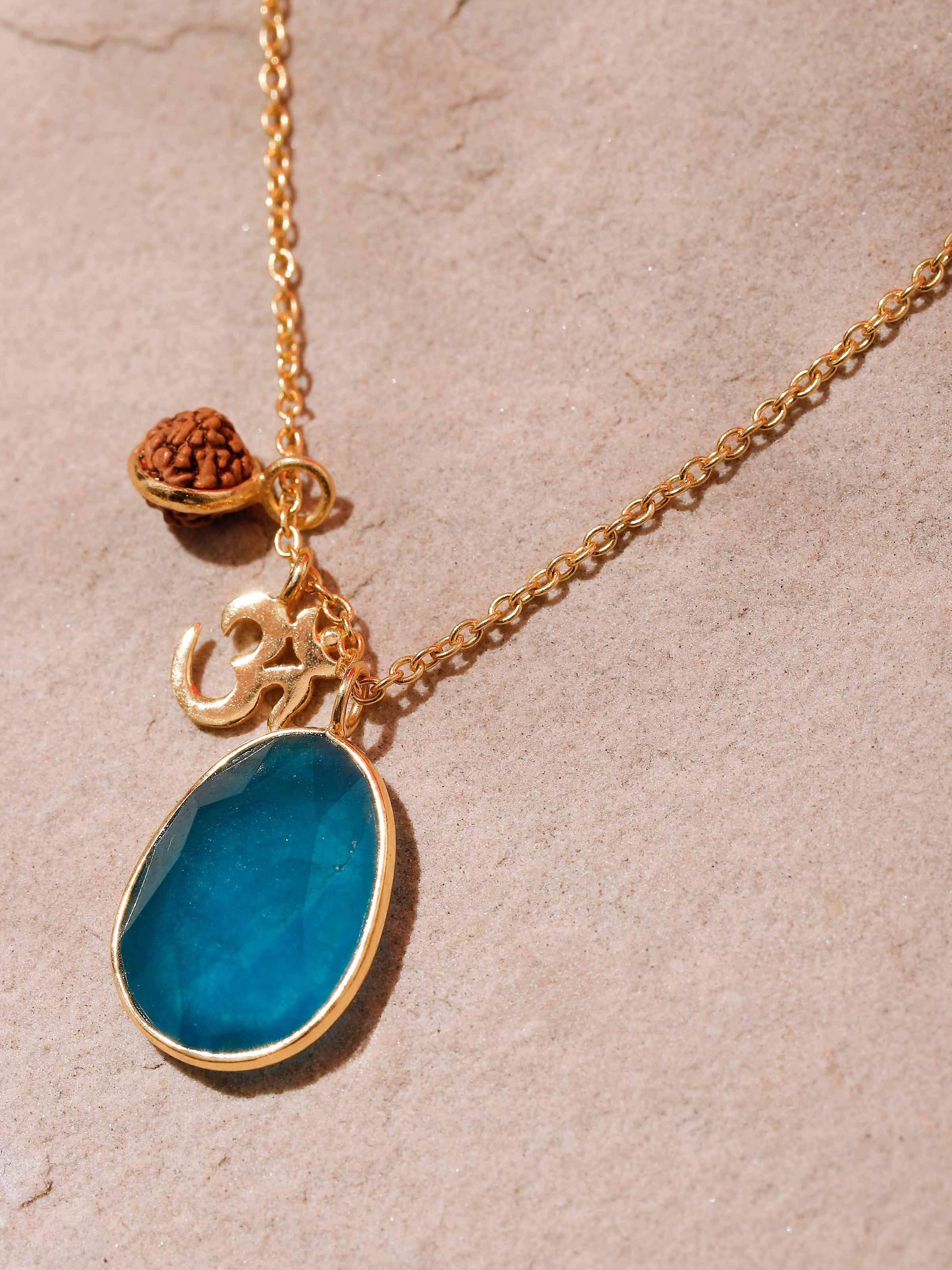 Detail shot of Rudraksha & Rose Quartz Necklace highlighting the intricate gold-plated design