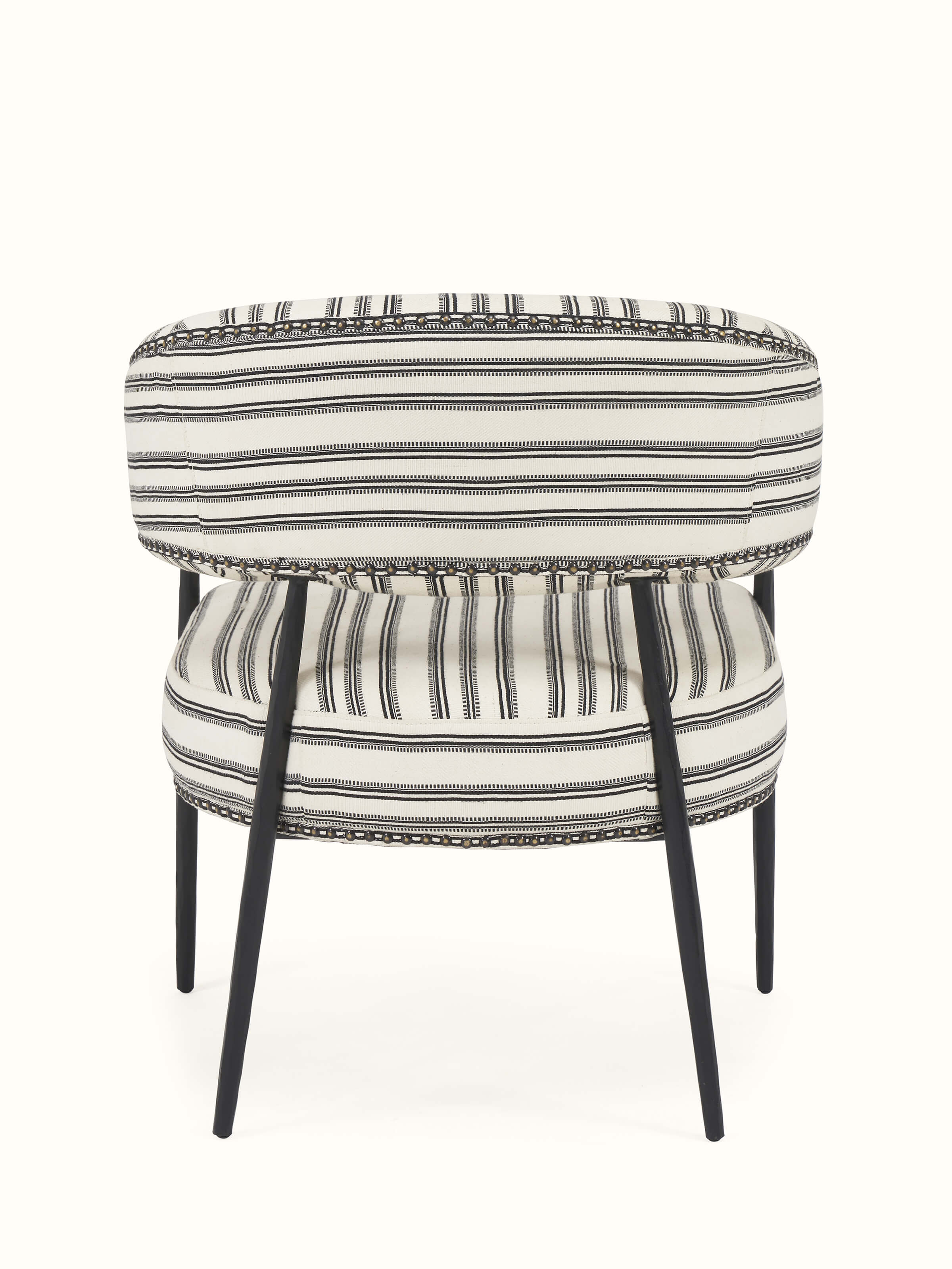 Close-up back view of upholstered metal armchair from Swadesh highlighting its elegant upholstery and sleek frame.