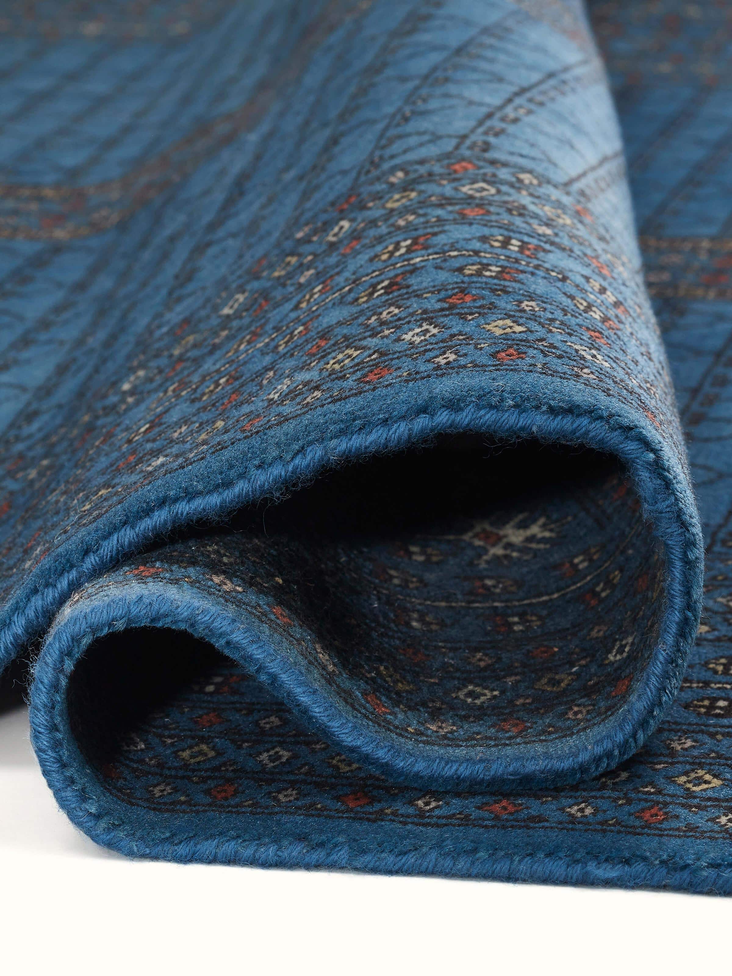 Detailed corner shot of Amritsari Parda Blue Wool Rug, showcasing hand-knotting and refined Gwalior artistry by Swadesh