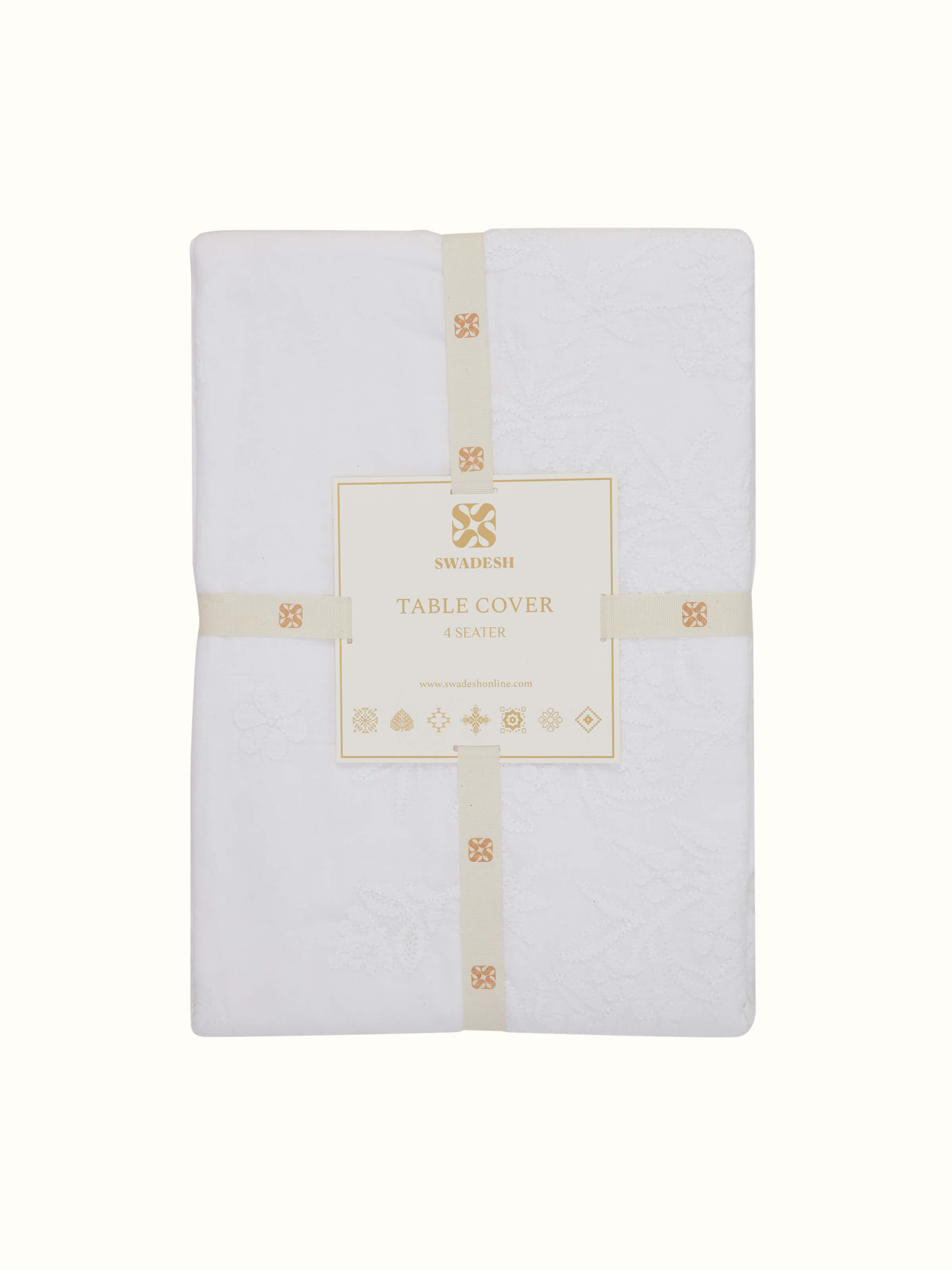 Close-up of Ananda white Chikankari table cover showing medallion embroidery and delicate cotton texture.