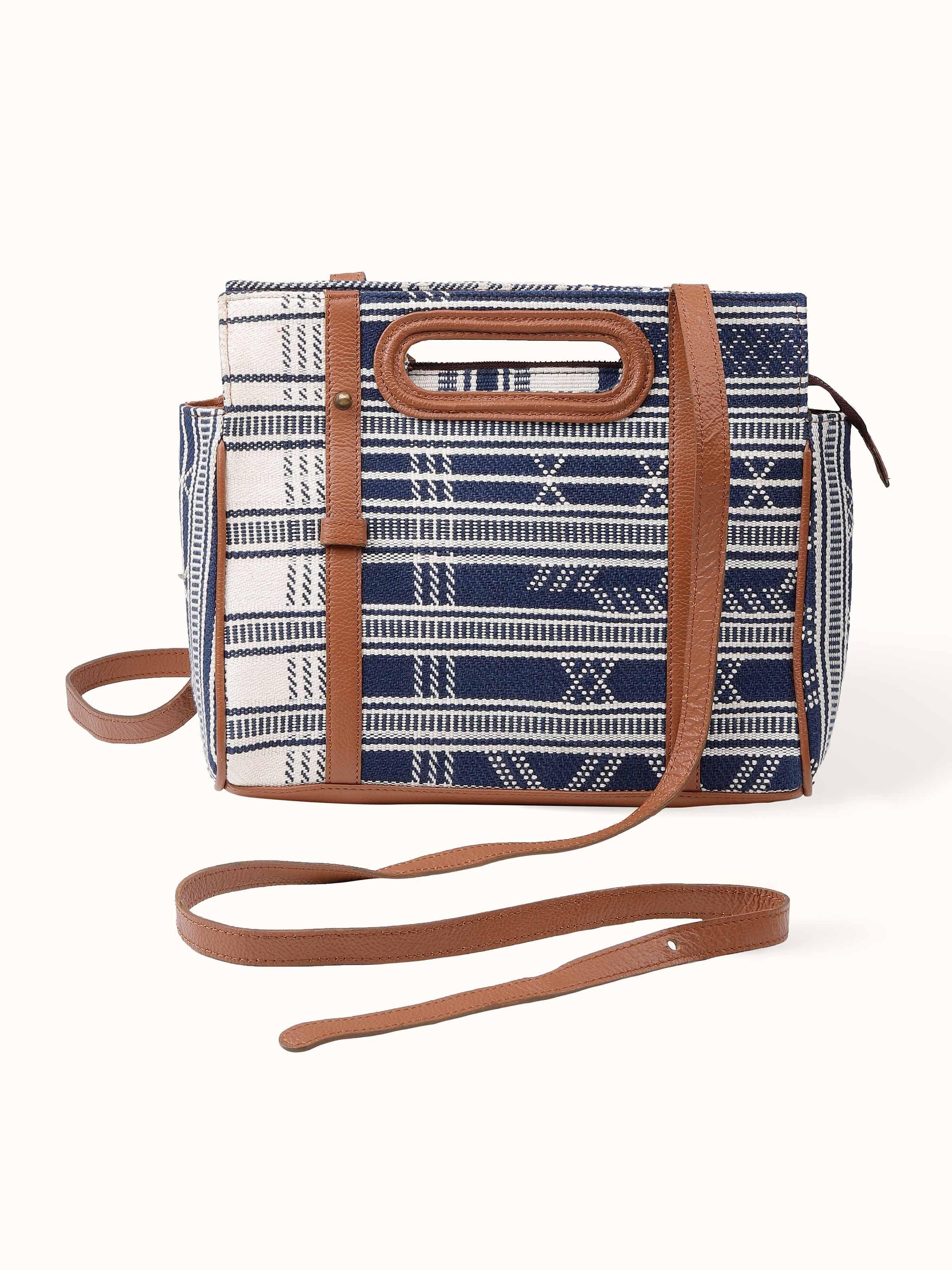 Front view of leather and textile extra-weft sling bag with handcrafted detailing.