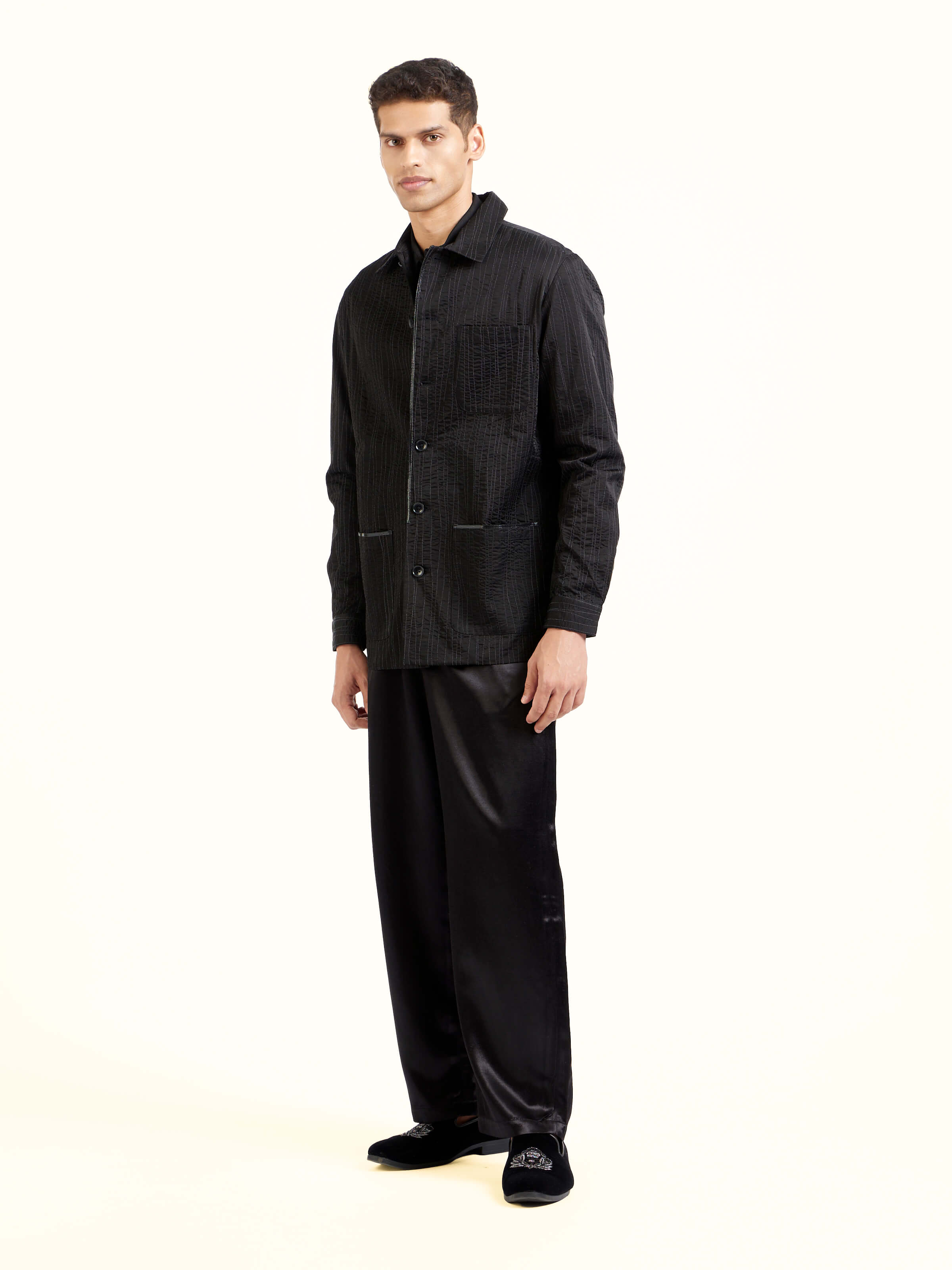 Side view of black quilting ethnic jacket highlighting structured fit