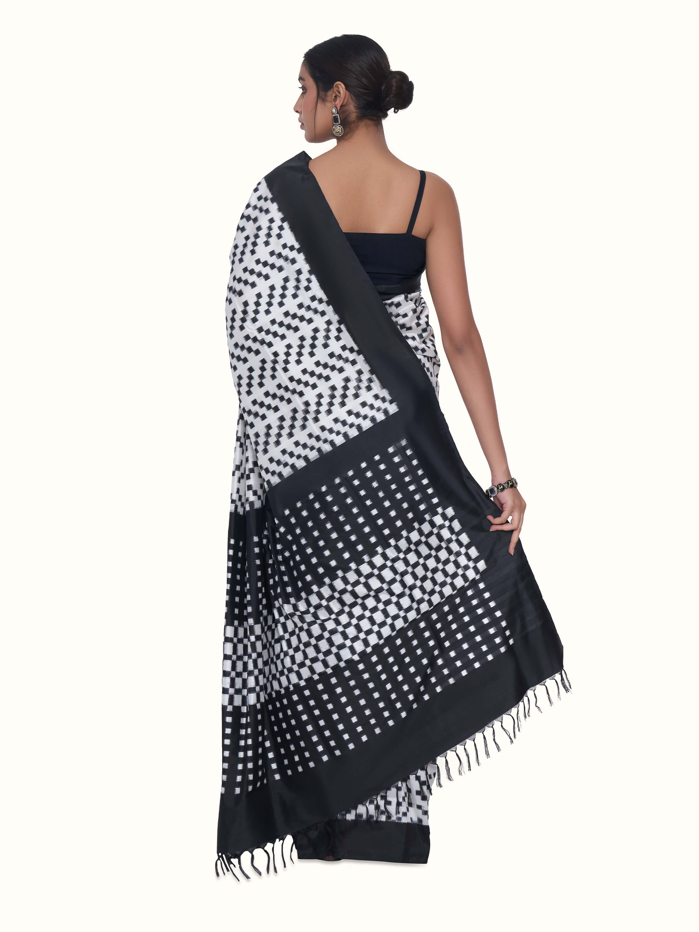 Back view of black silk double ikat saree displaying patterned pallu design