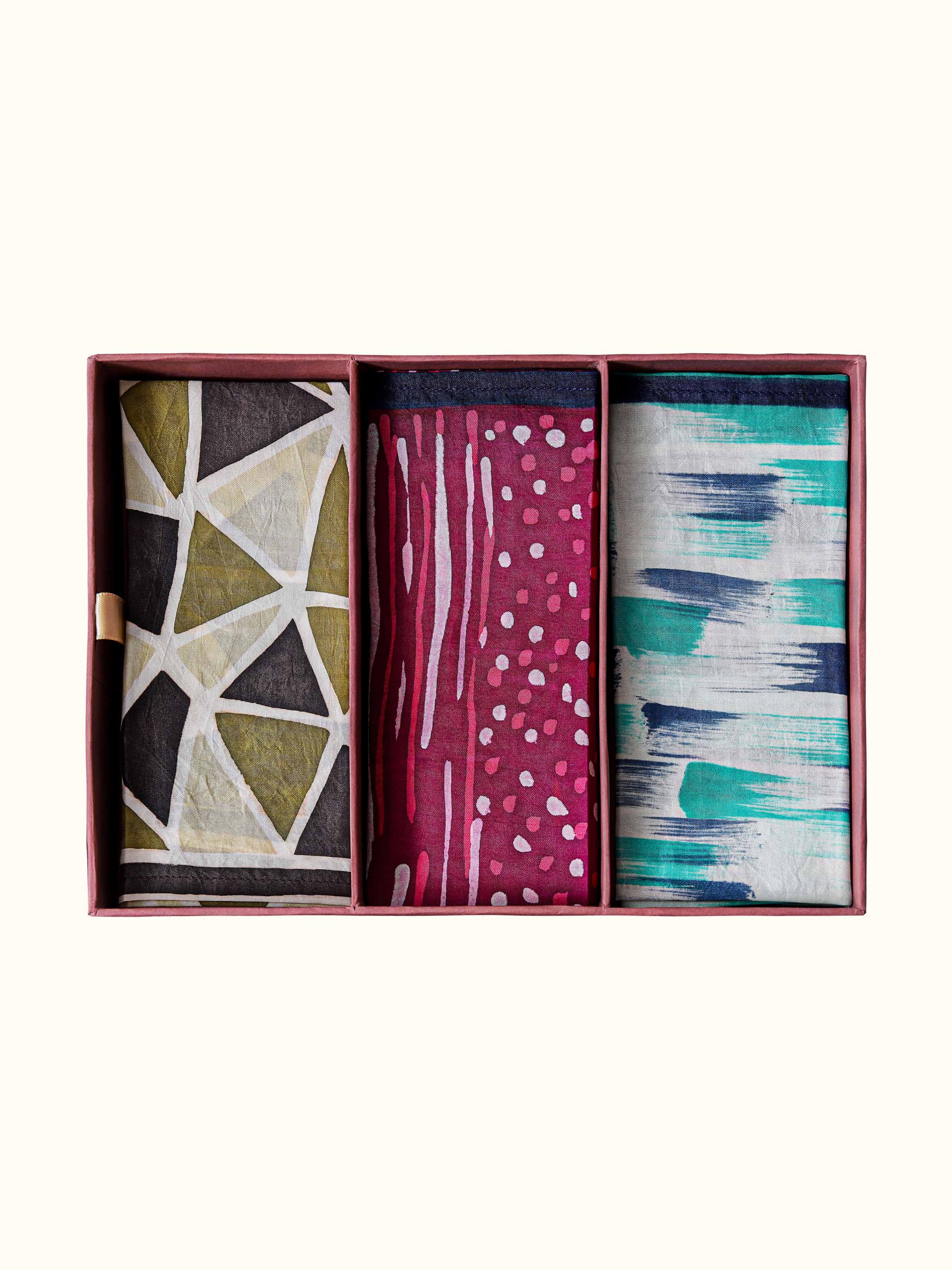 close-up view of assorted silk discharge block printed pocket squares texture