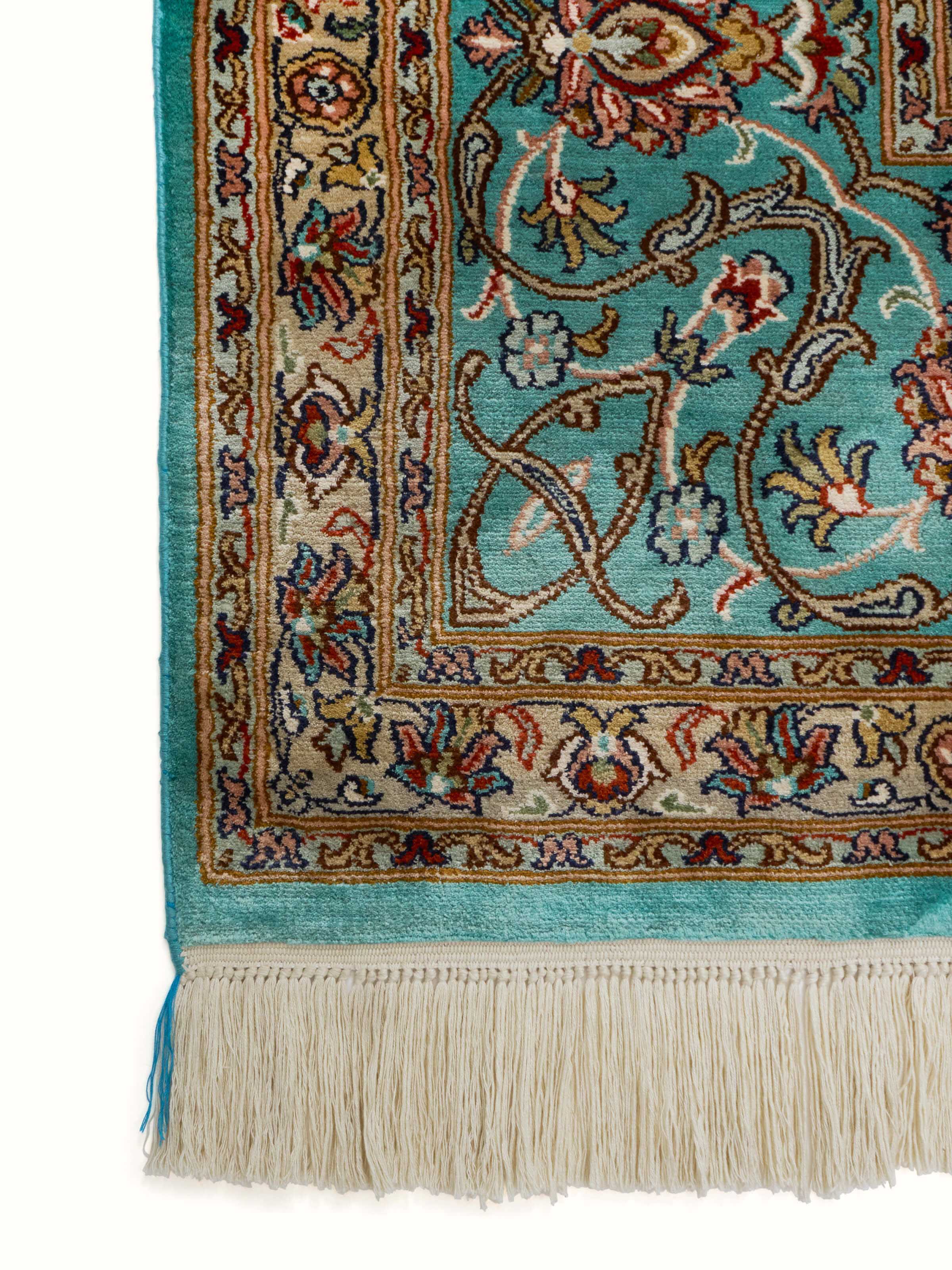 Design close-up of hand-knotted blue Tabriz carpet in fine Kashmir silk