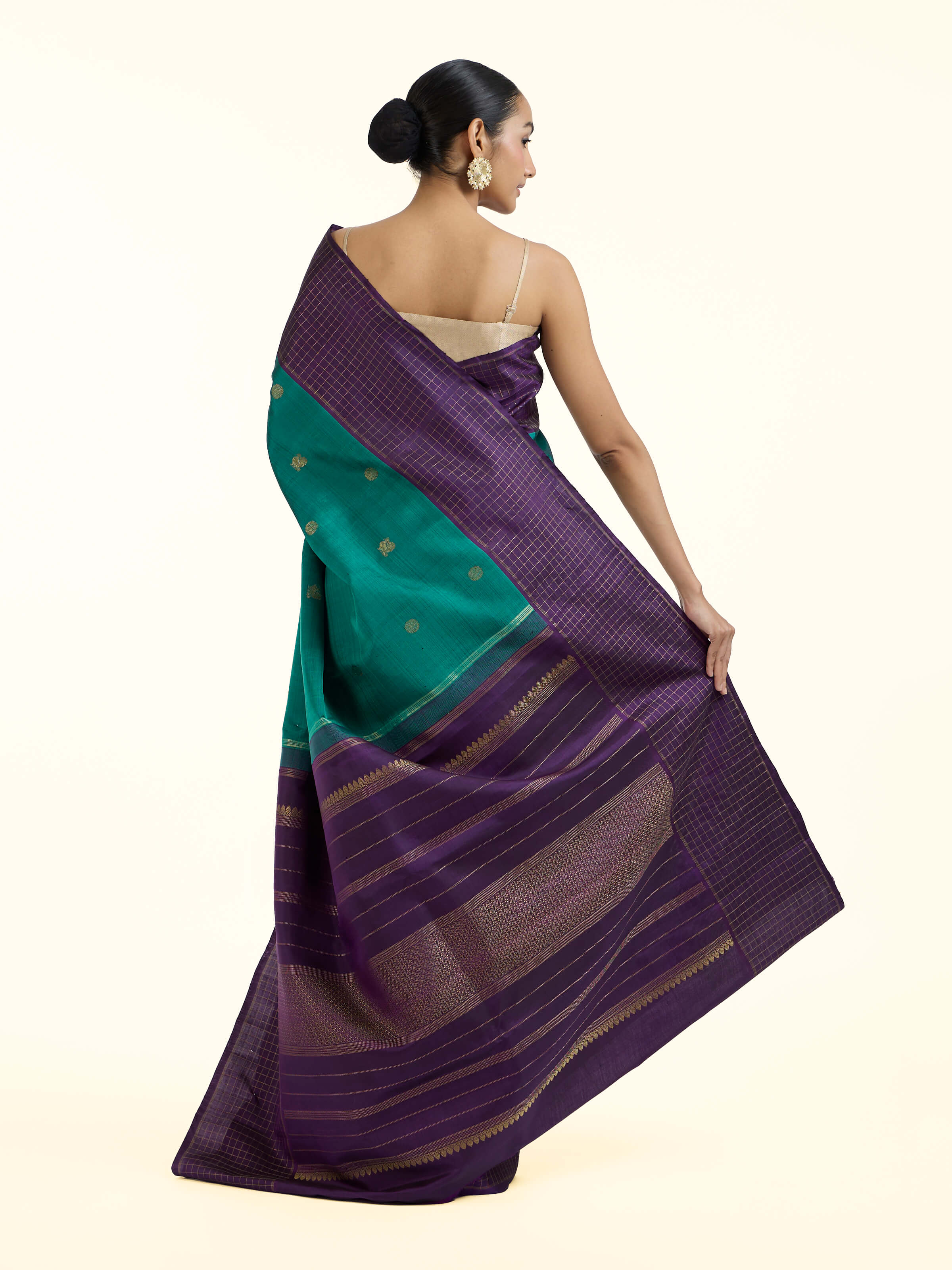 Back view of green silk Kancheepuram saree displaying ornate pallu design