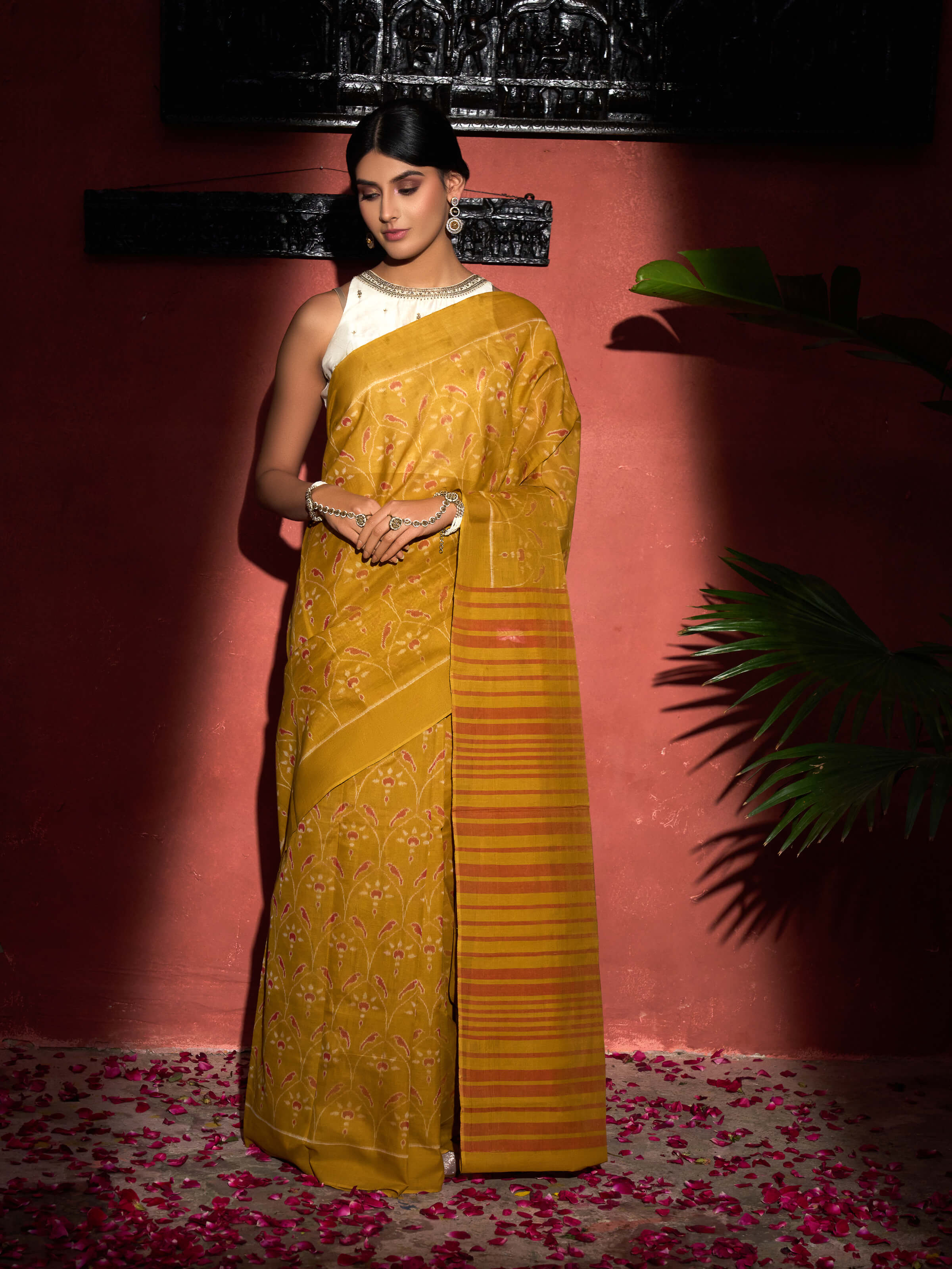 Side view of mustard cotton Odisha ikat bandha saree with comfortable drape and woven border