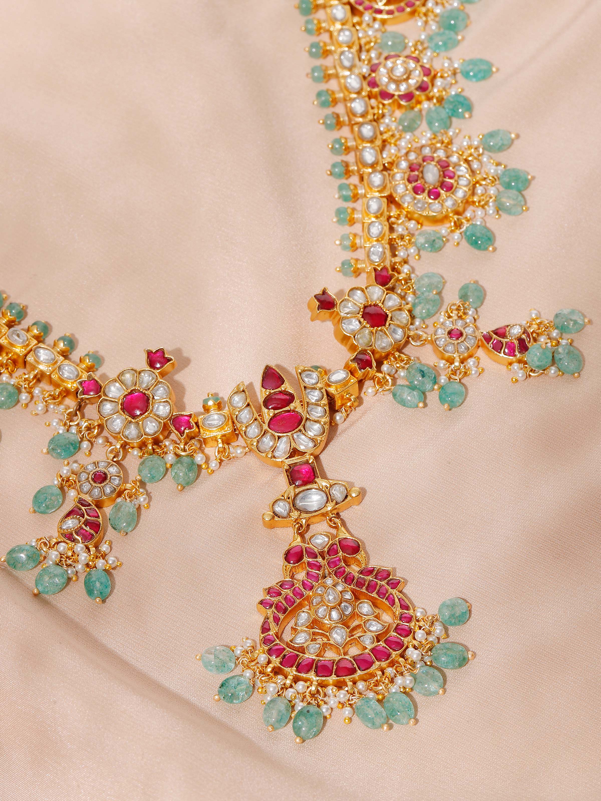 Close-up of handcrafted silver smithing detail on long necklace