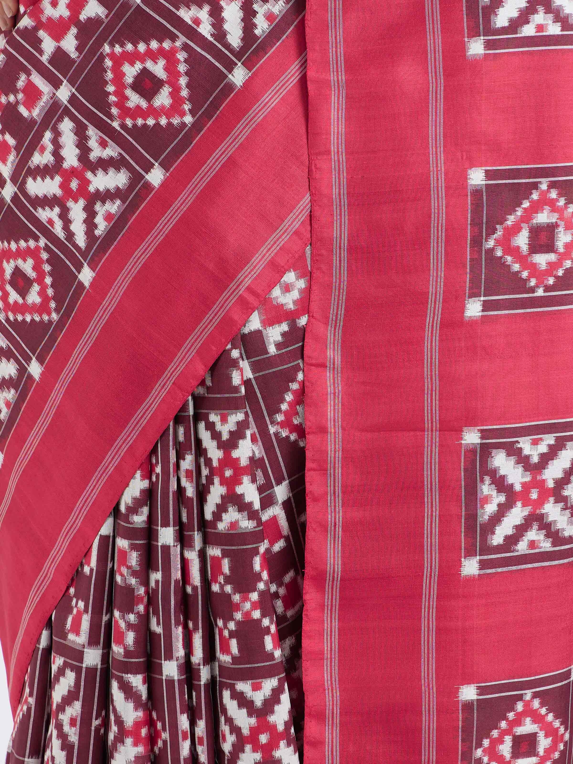 Detail view of red mulberry silk Ikat saree showcasing fine silk texture and resist-dyed craftsmanship