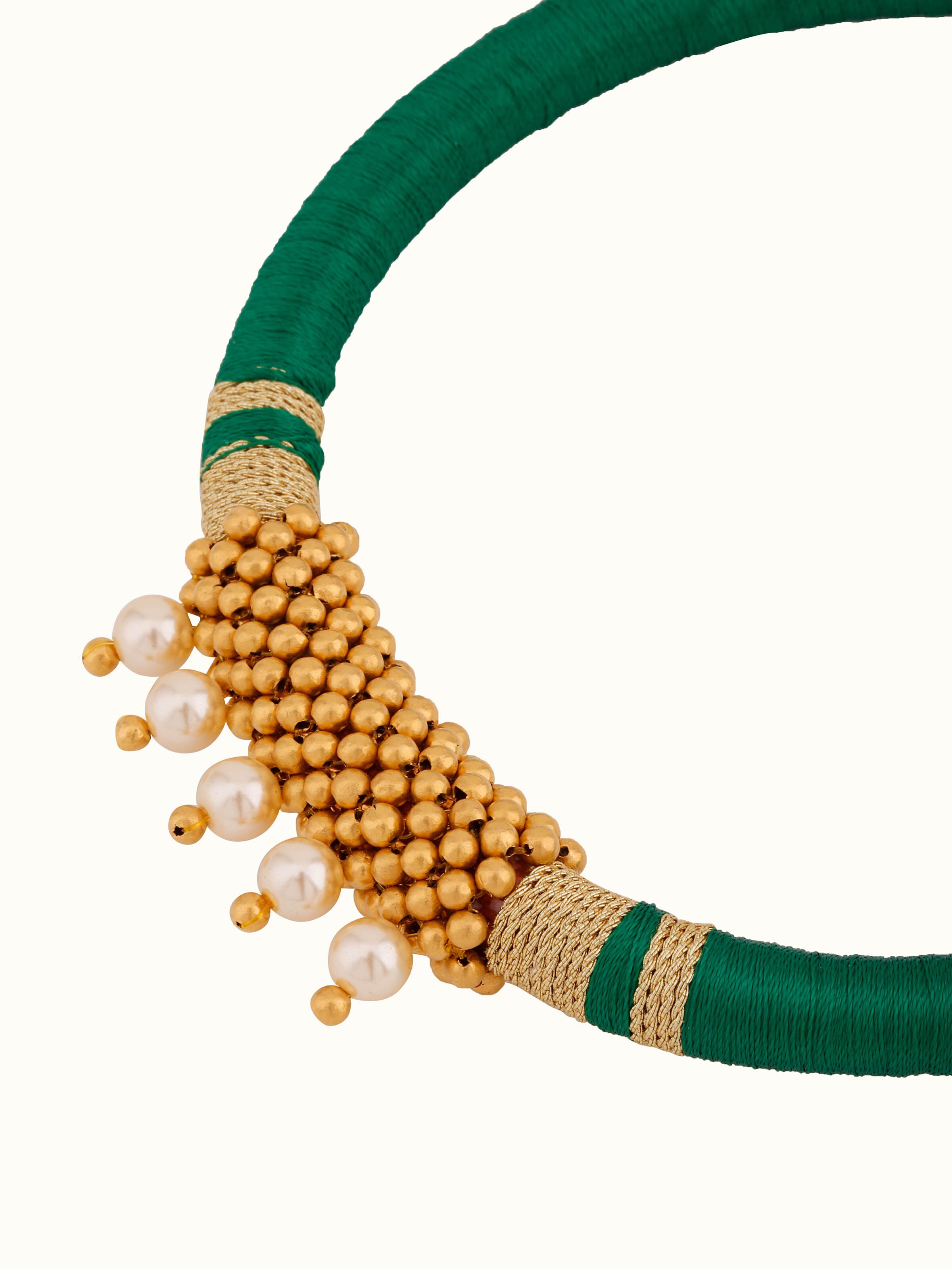Side view of Thushi 22 karat collar necklace
