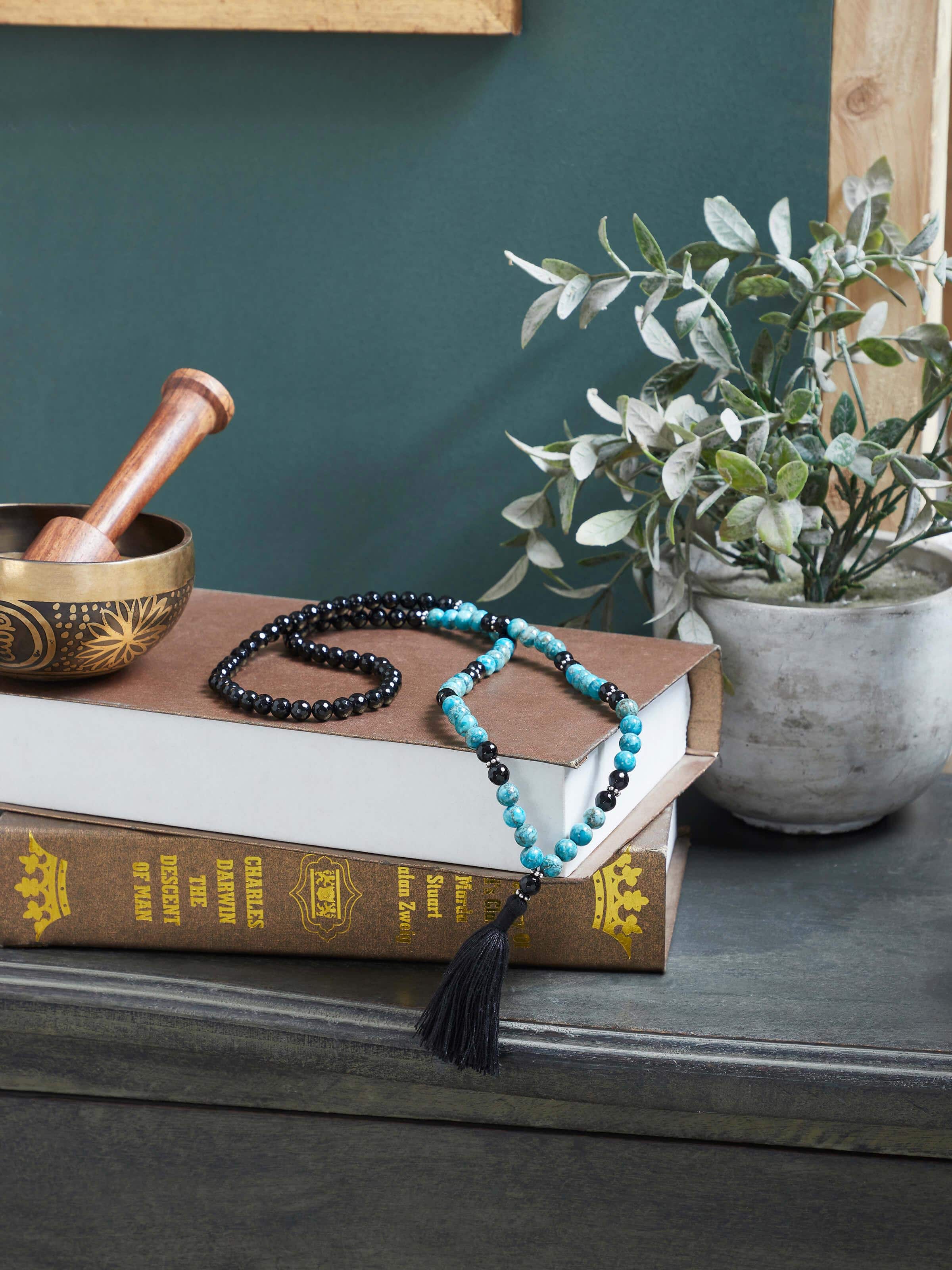 Lifestyle view of Black Onyx & Turquoise Silver Mala styled with modern attire to highlight spiritual elegance